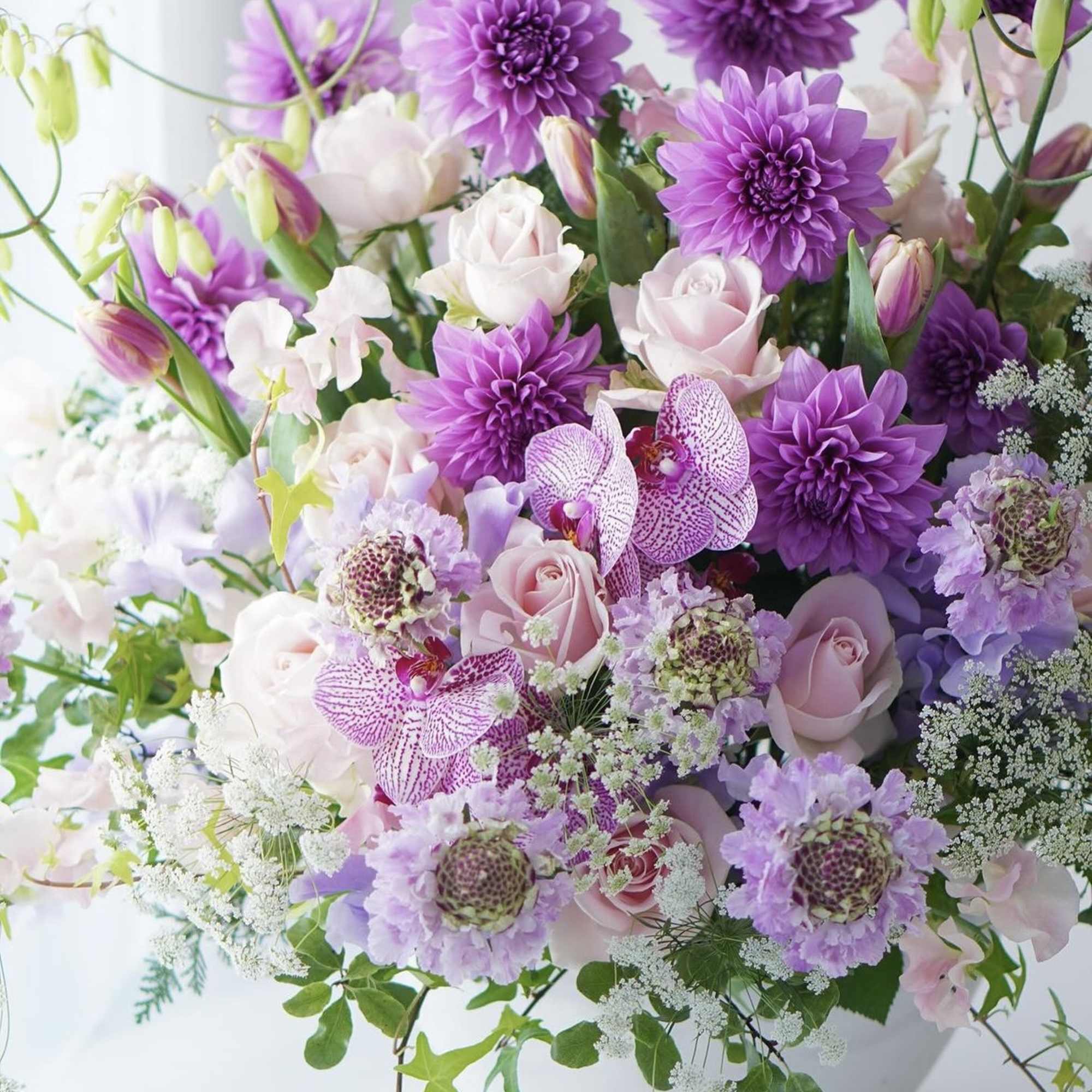 Lavender and blush floral arrangement in a white vase