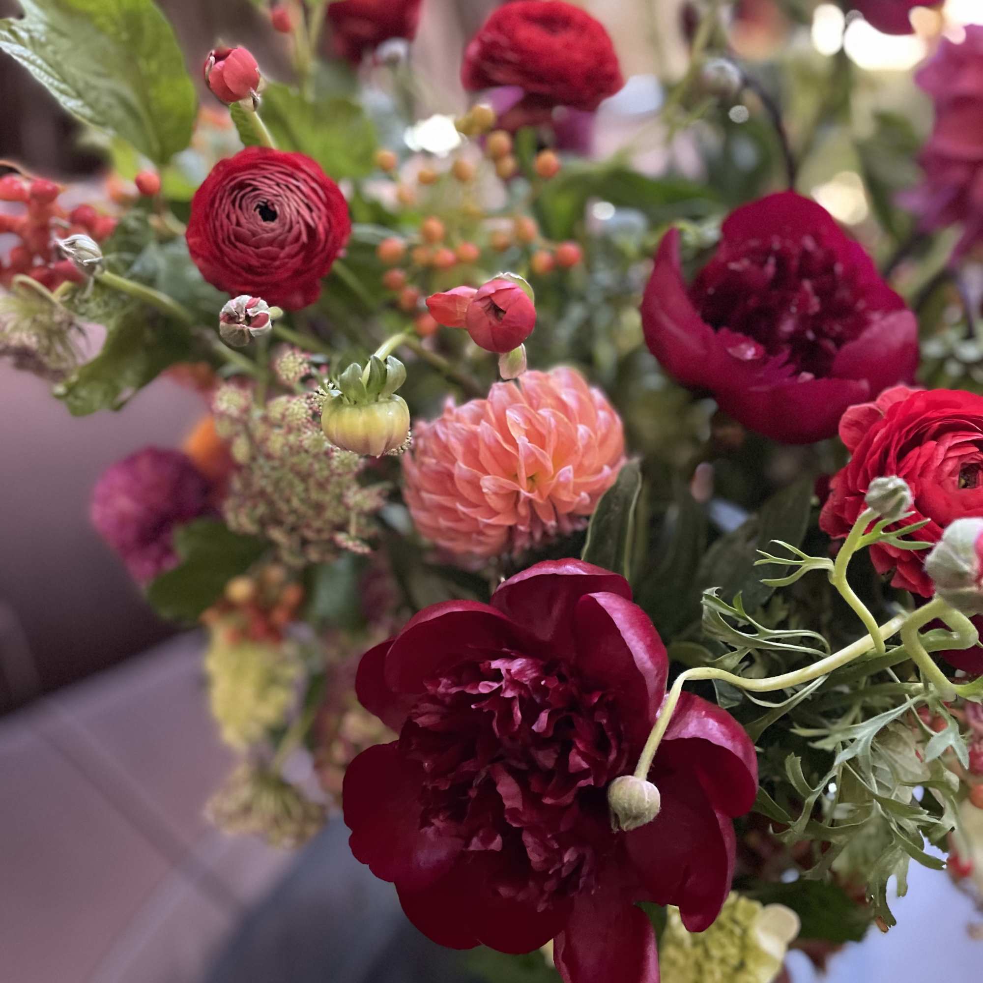 Bouquet of deep red and pink flowers with green foliage