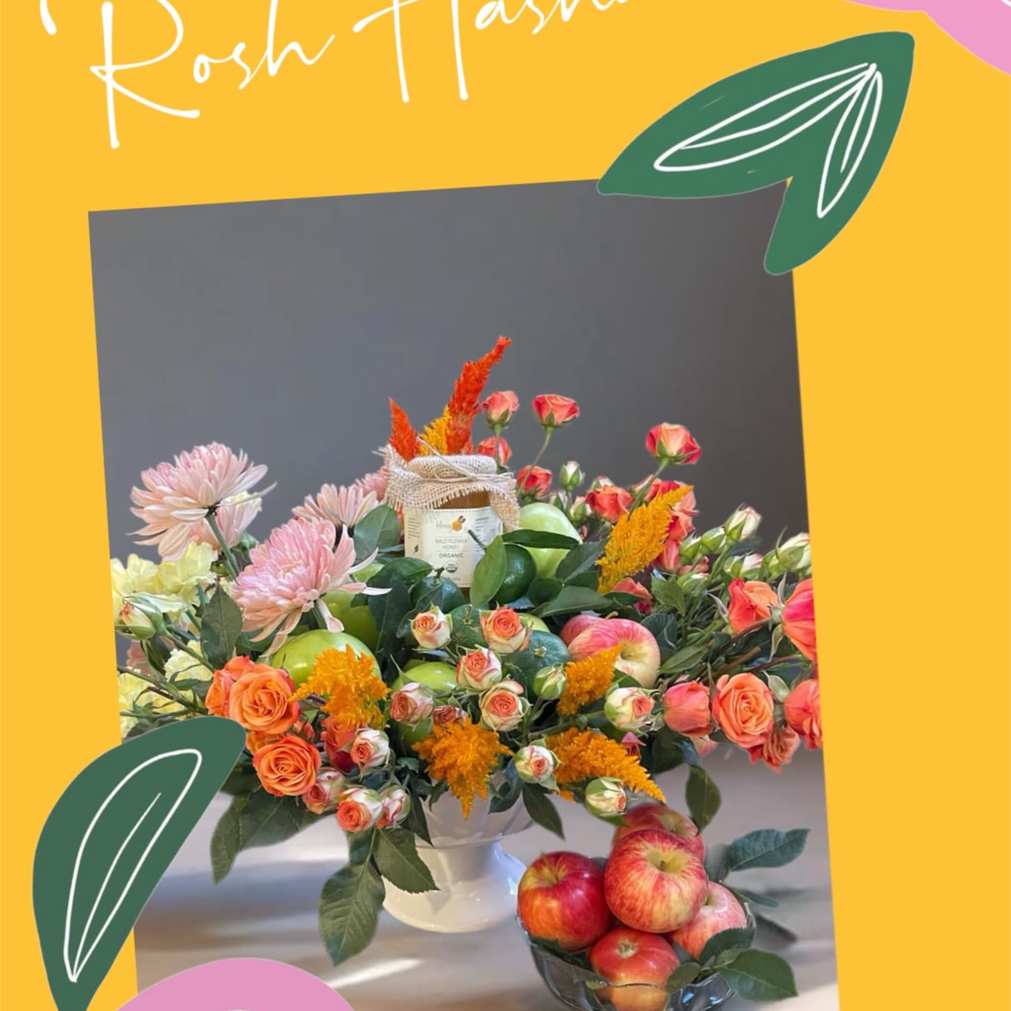 Fruit and flower arrangement with roses, chrysanthemums, and apples in a white vase