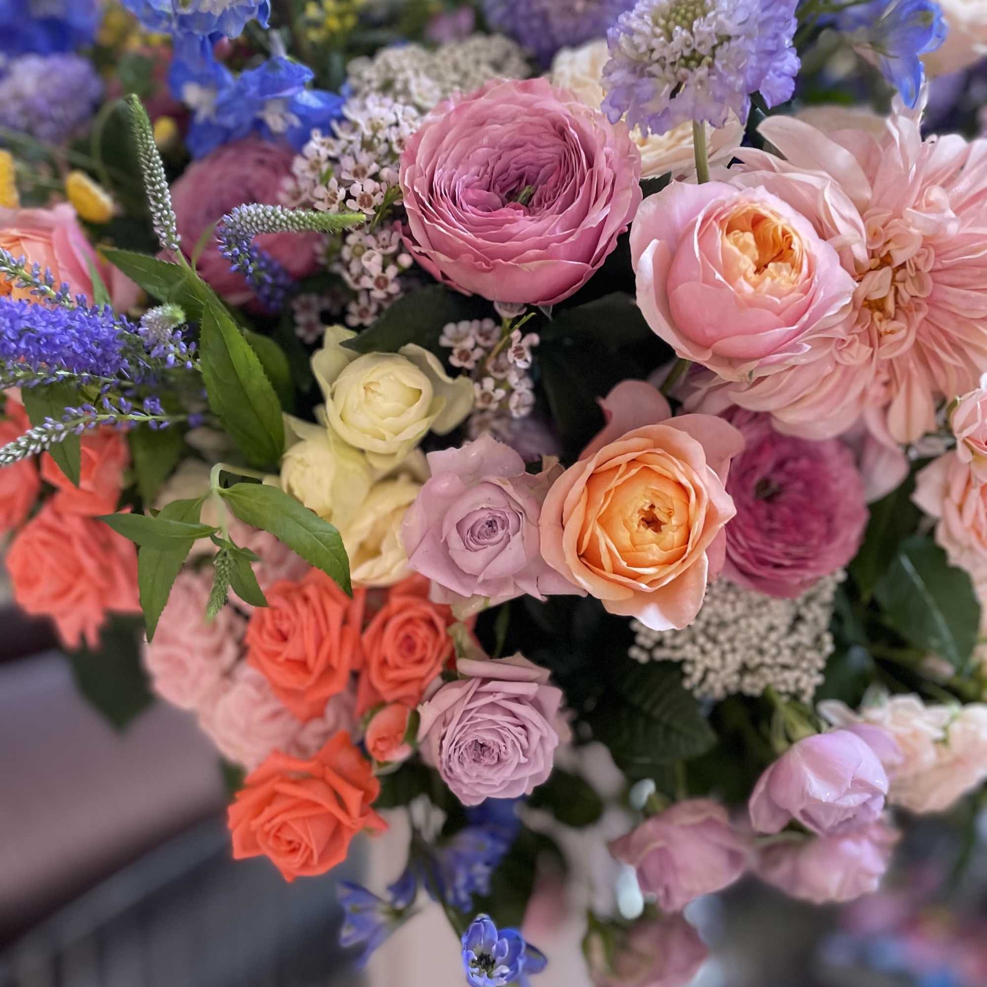 Mixed bouquet of pink, peach, and blue flowers