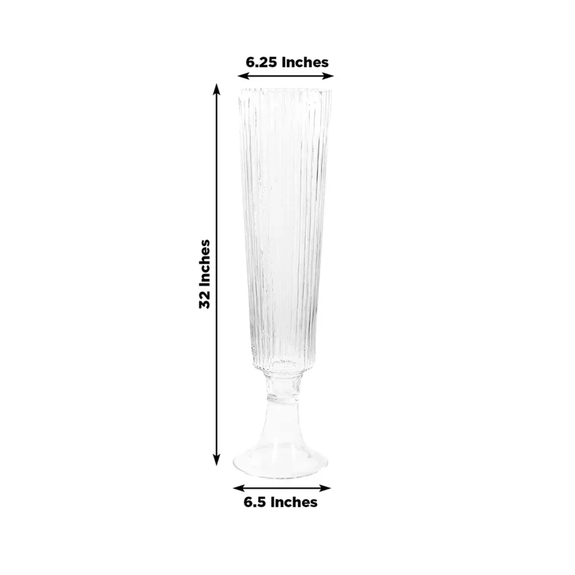 Tall clear glass vase with fluted sides and a pedestal base
