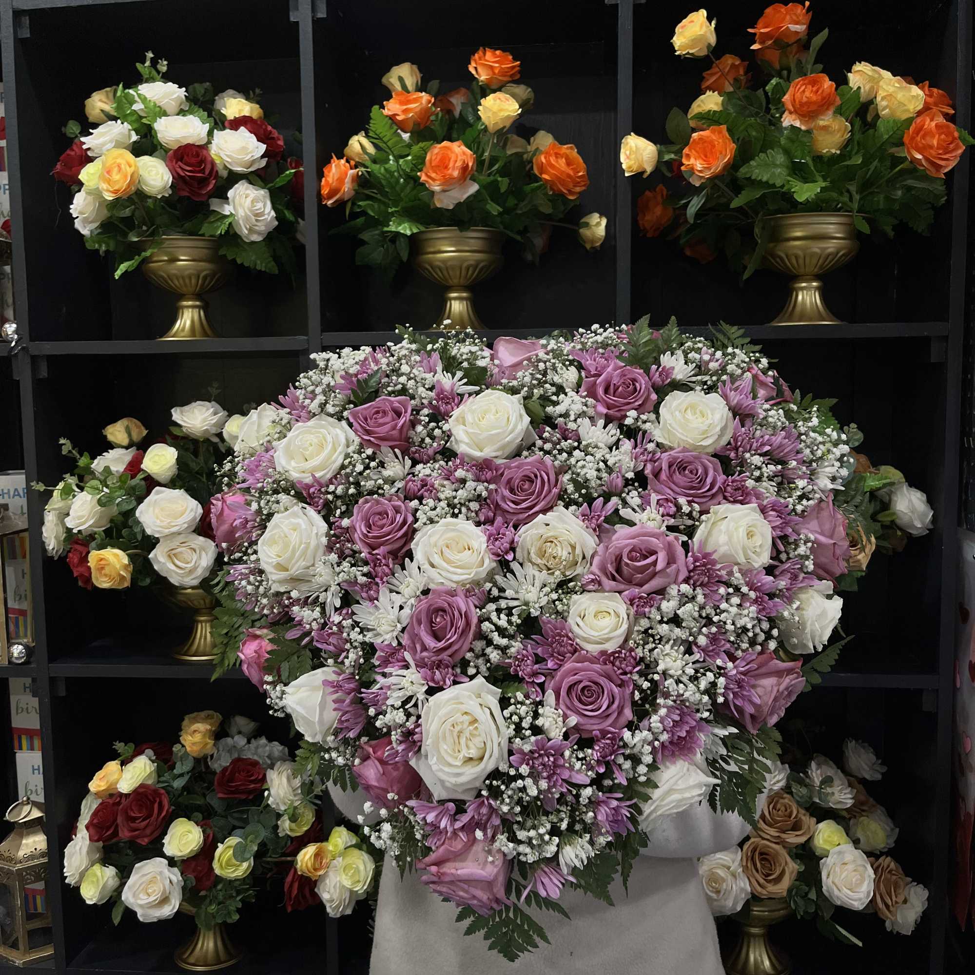 Large bouquet of lavender and white roses with small filler flowers