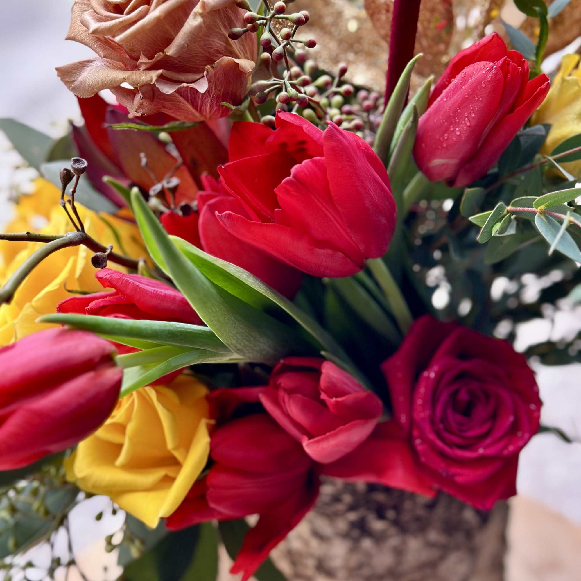 Bouquet of red and yellow tulips with roses