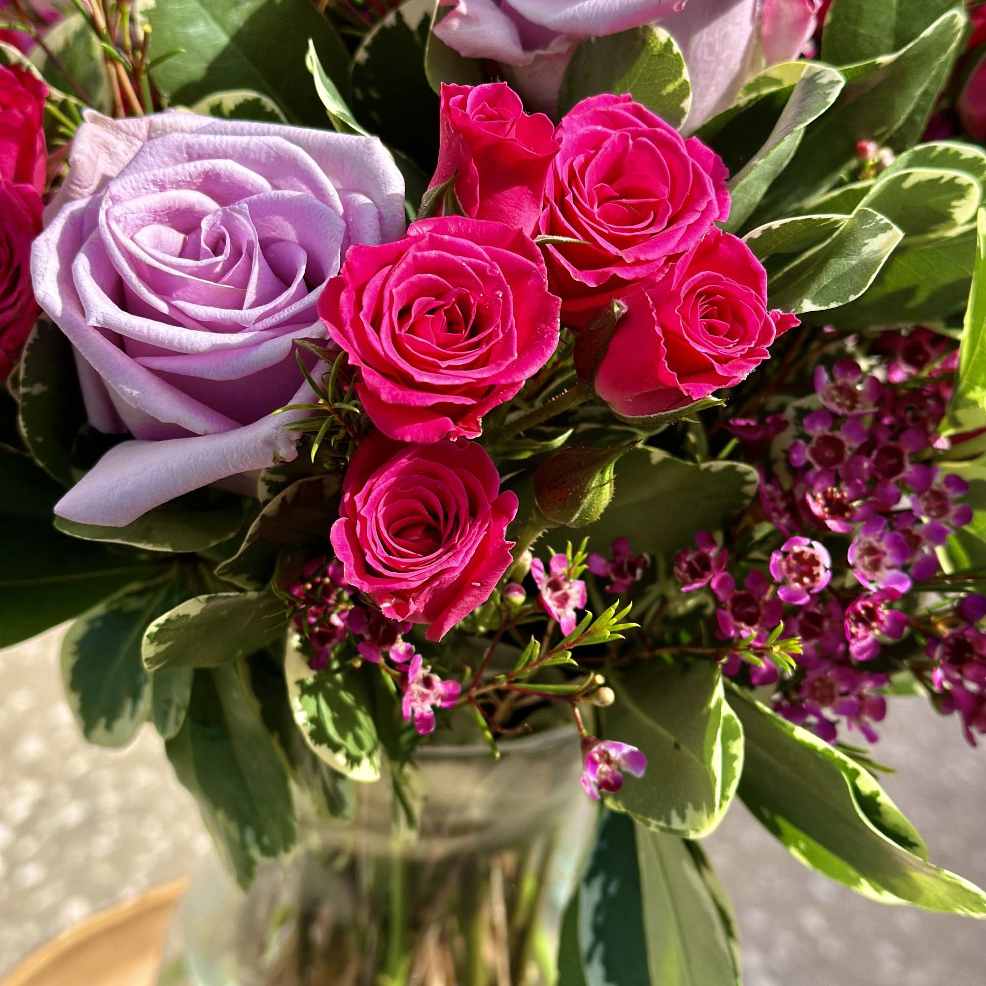 Bouquet of pink and lavender roses in a glass vase