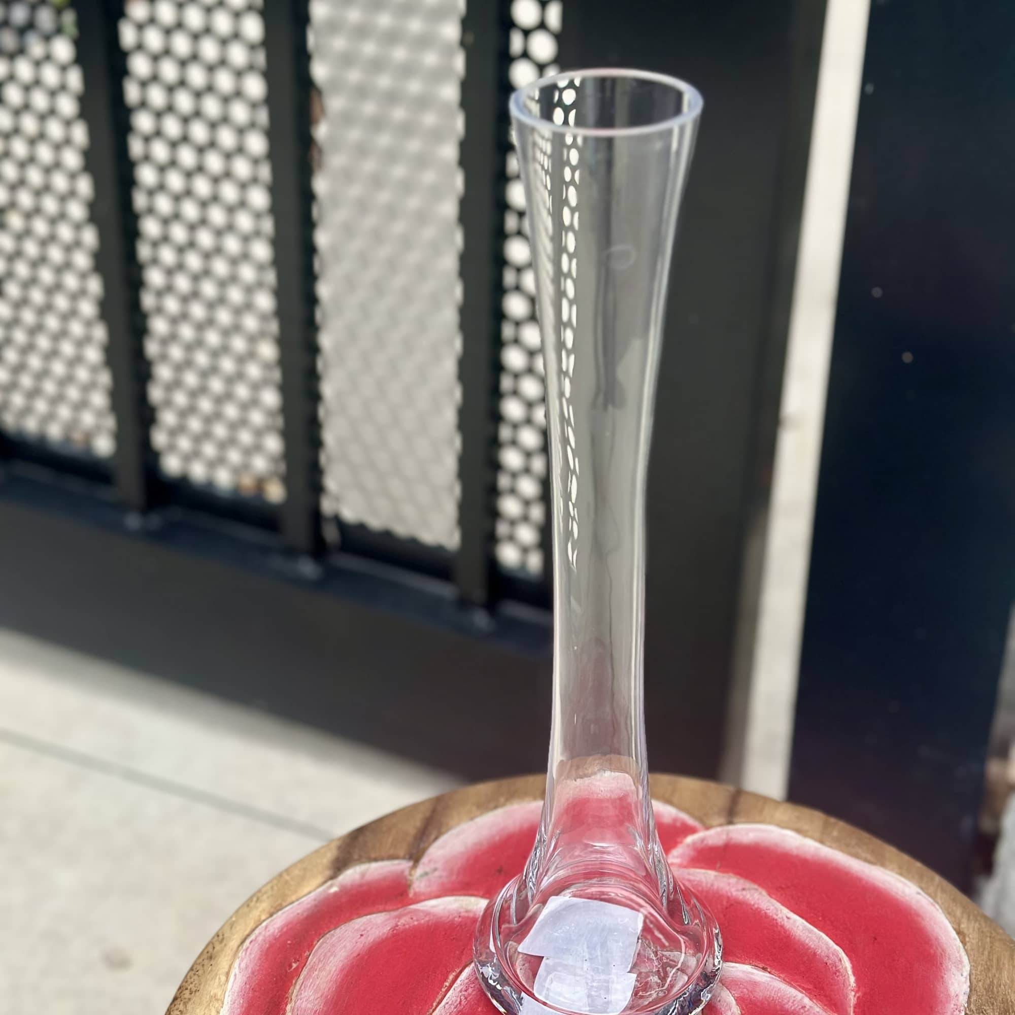 Clear glass trumpet vase on a pink flower-shaped base