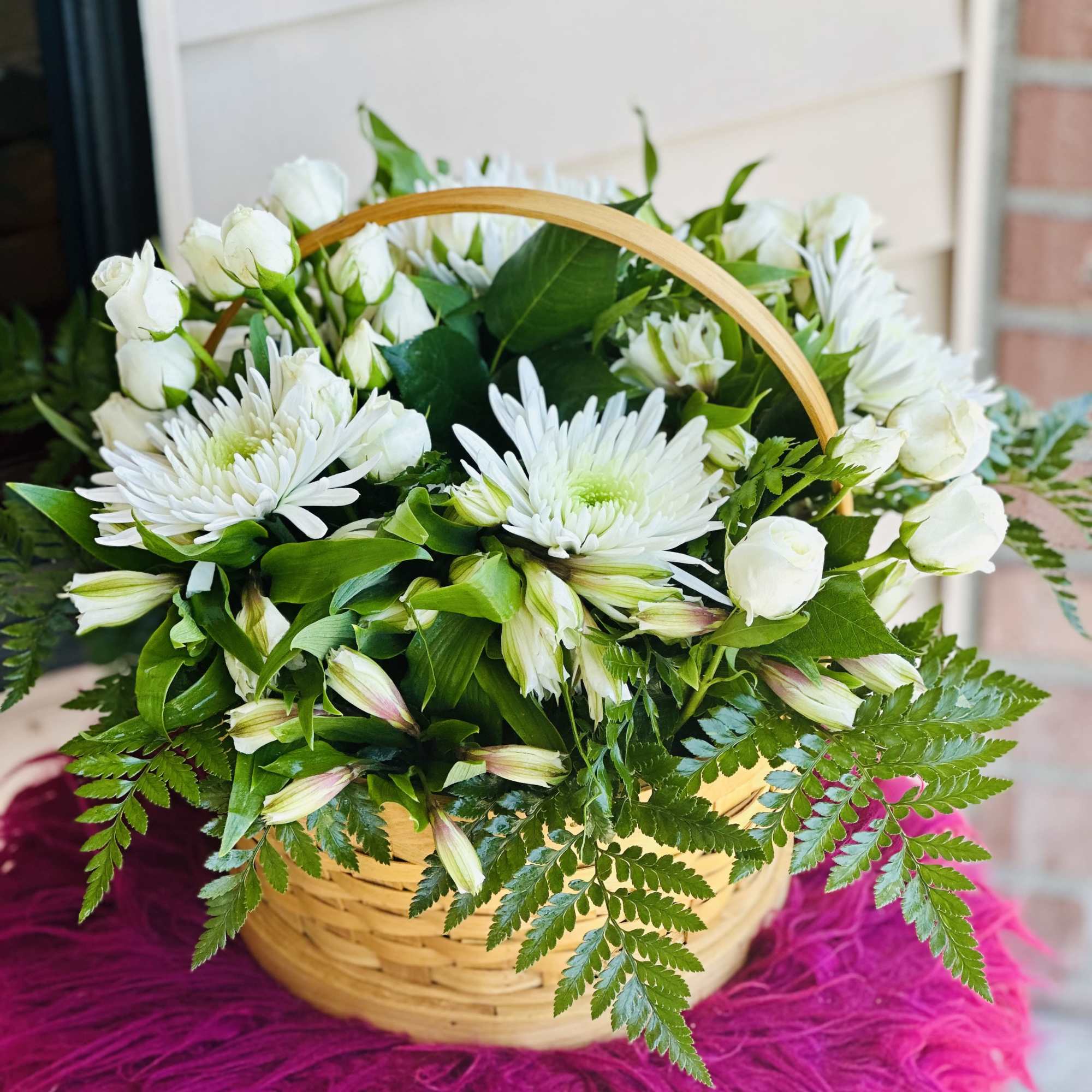 Basket of white flowers with green foliage and a wooden handle, photo 2 of 2