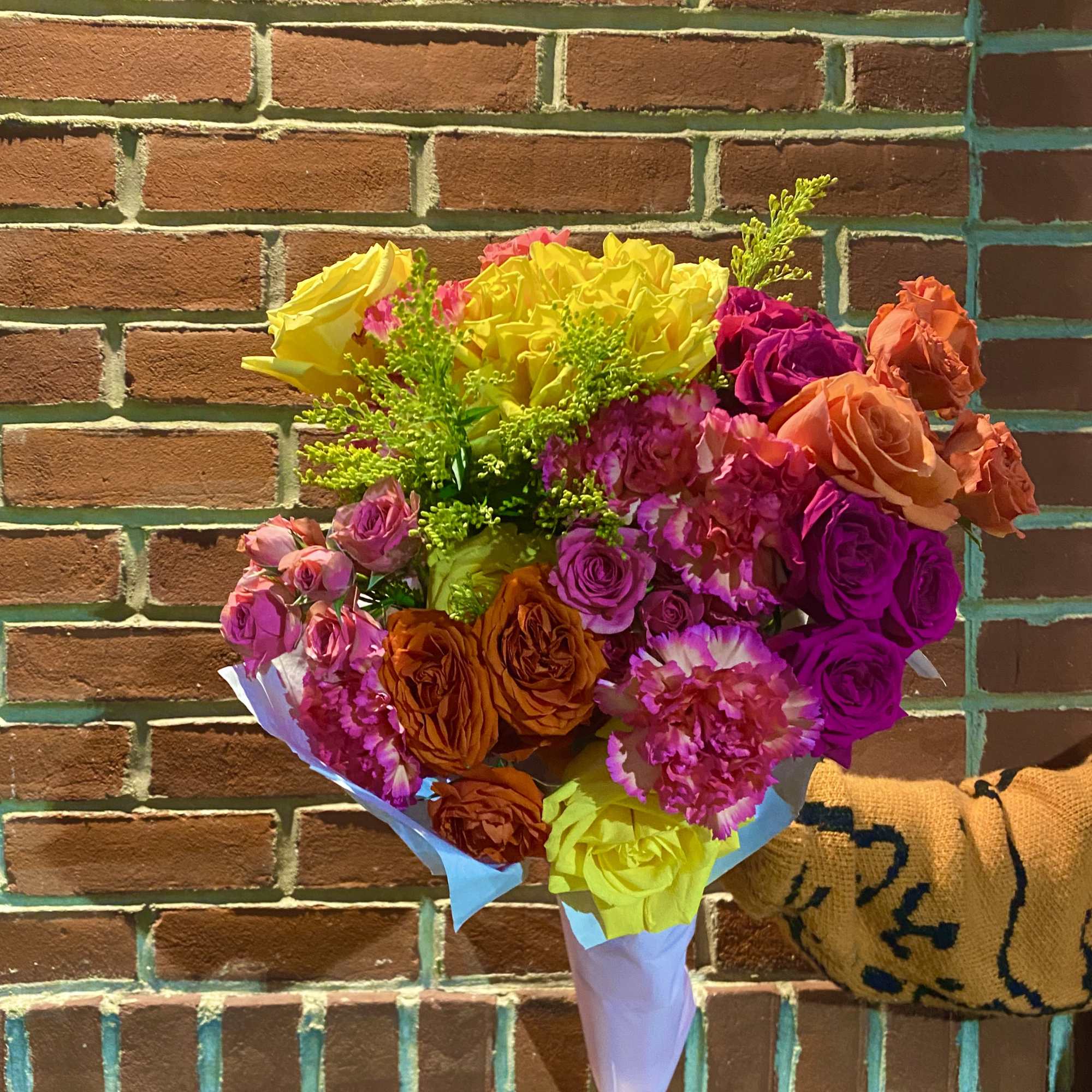Bright mixed bouquet of roses and carnations wrapped in white paper, photo 5 of 6