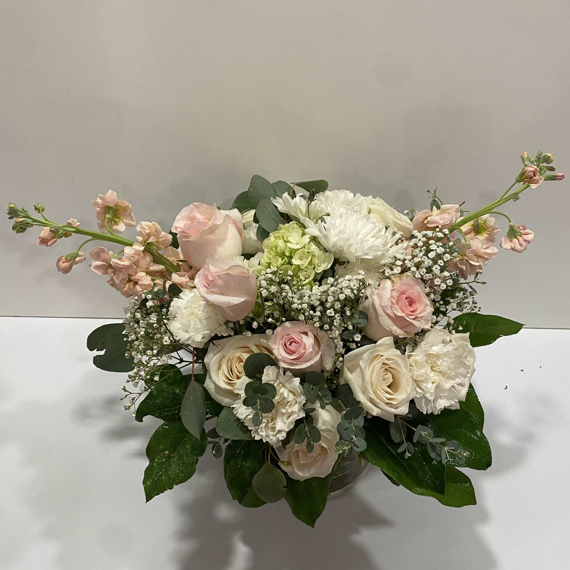 Blush and white rose bouquet in a glass vase