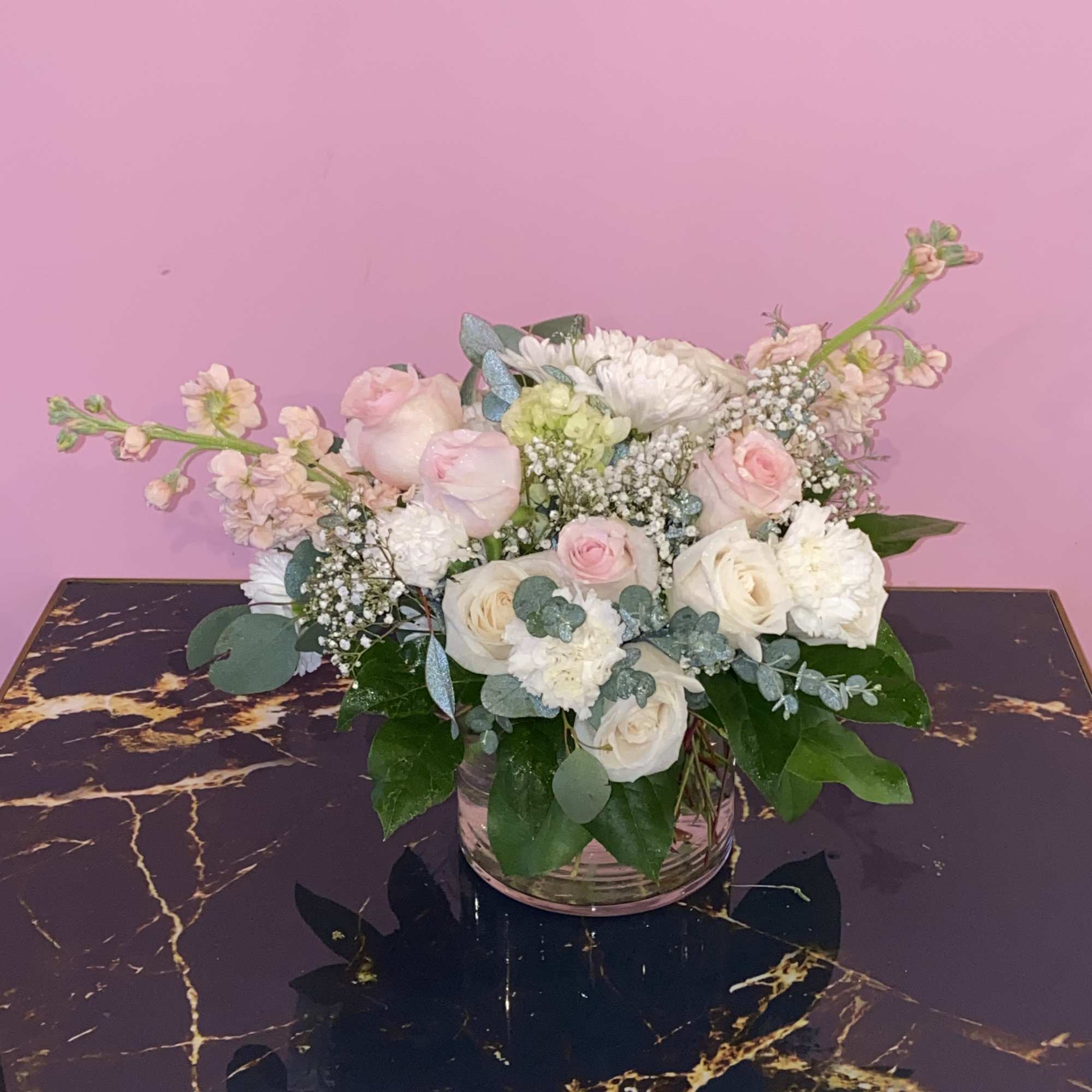 Pink and white floral arrangement in a clear glass vase