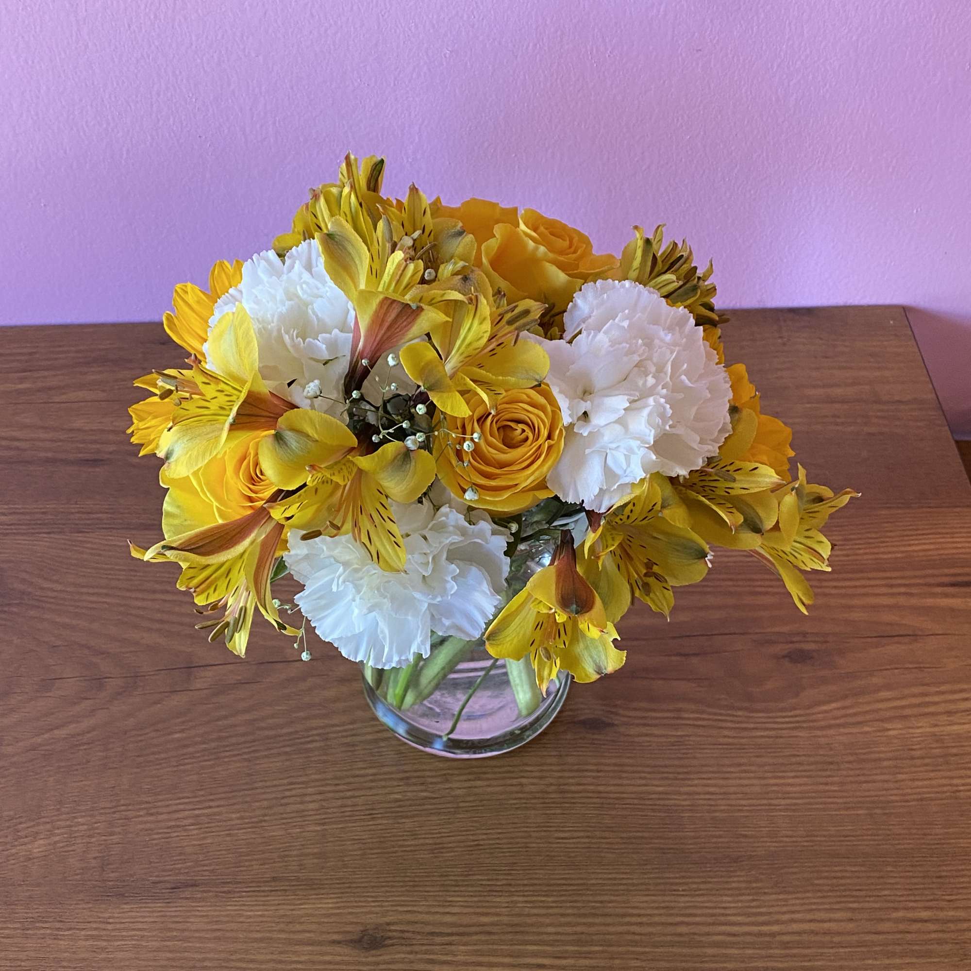 Yellow and white bouquet in a clear glass vase