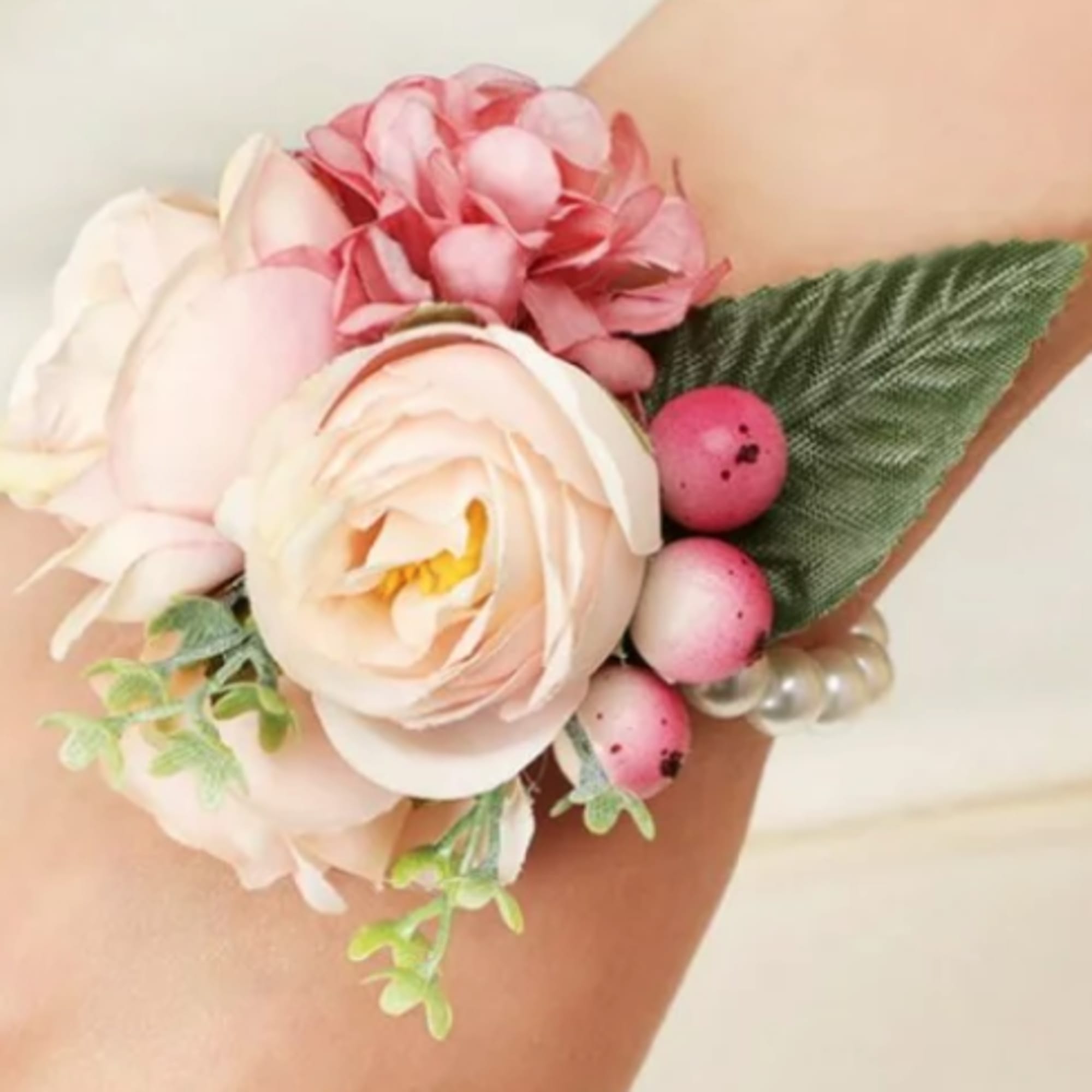 Pink and white floral wrist corsage with pearl accents