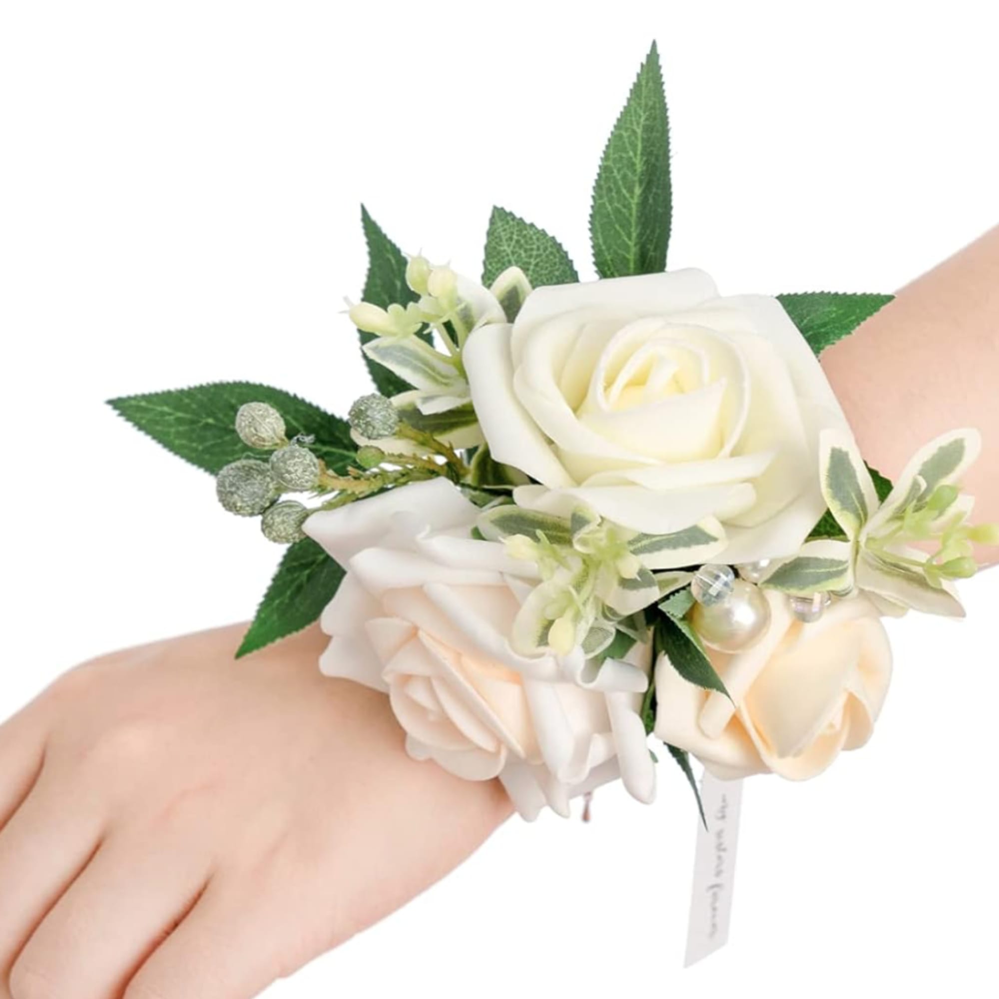White and blush rose wrist corsage with green leaves and pearl accents