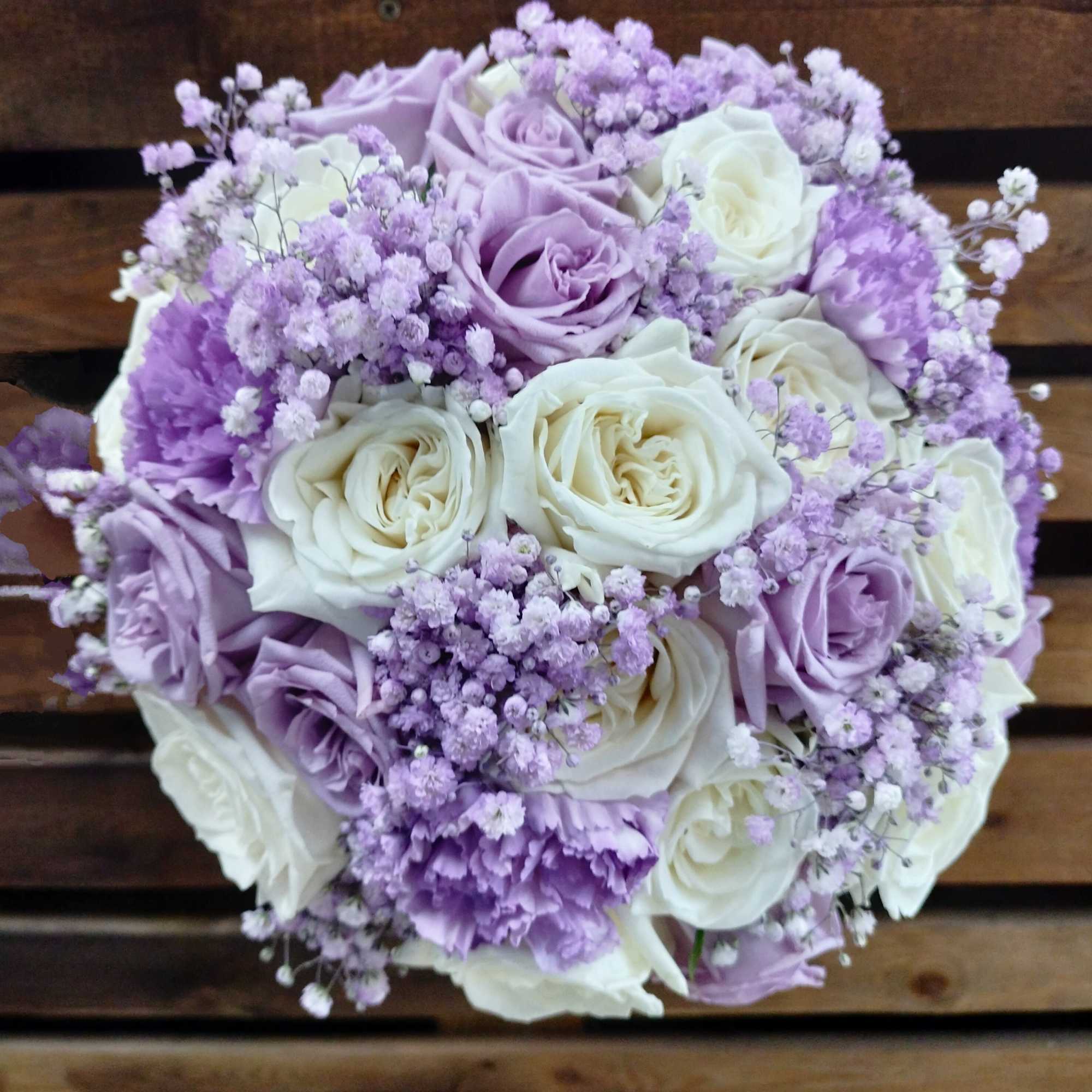 Bouquet of lavender and white roses with purple filler flowers