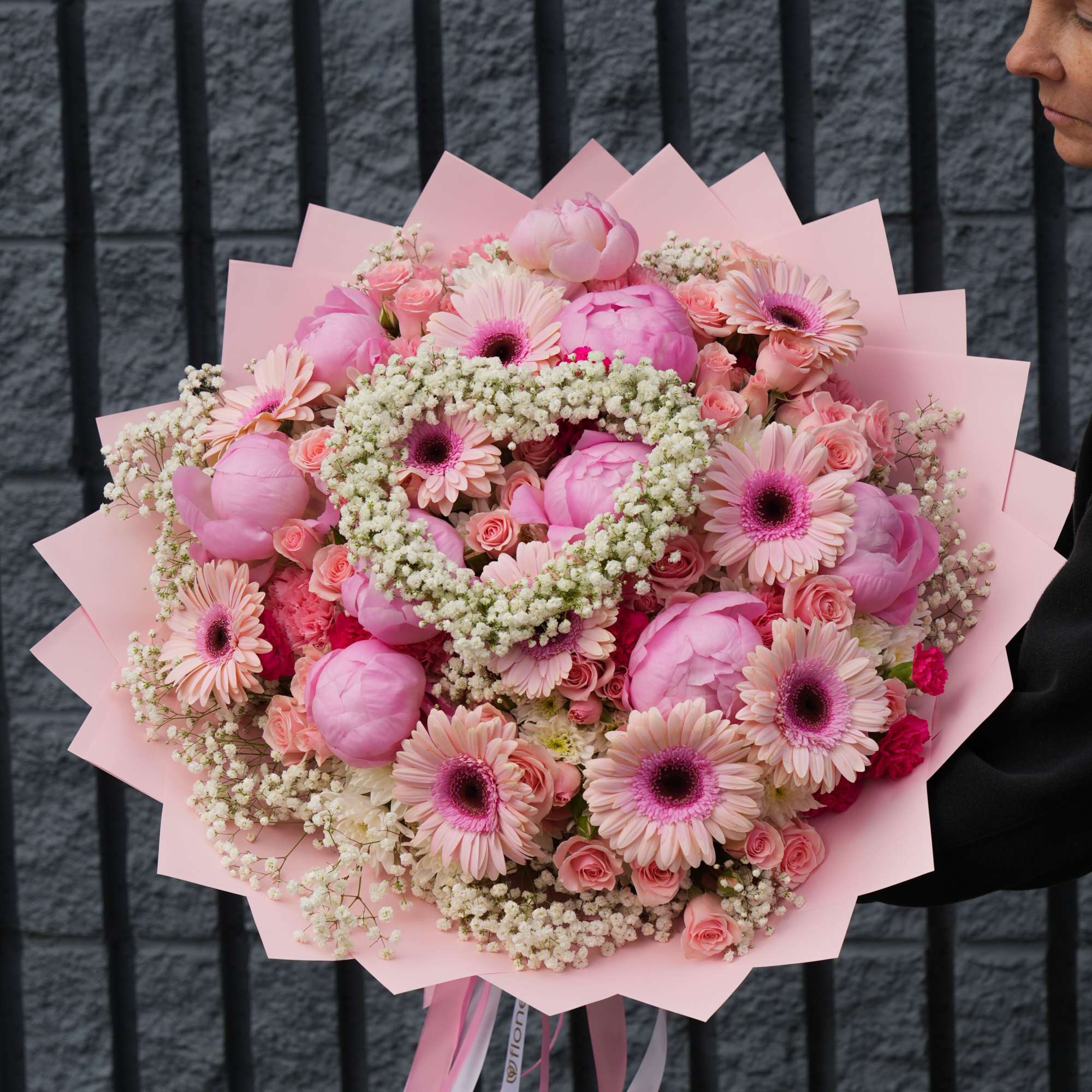 Large pink bouquet with gerbera daisies and roses wrapped in pink paper