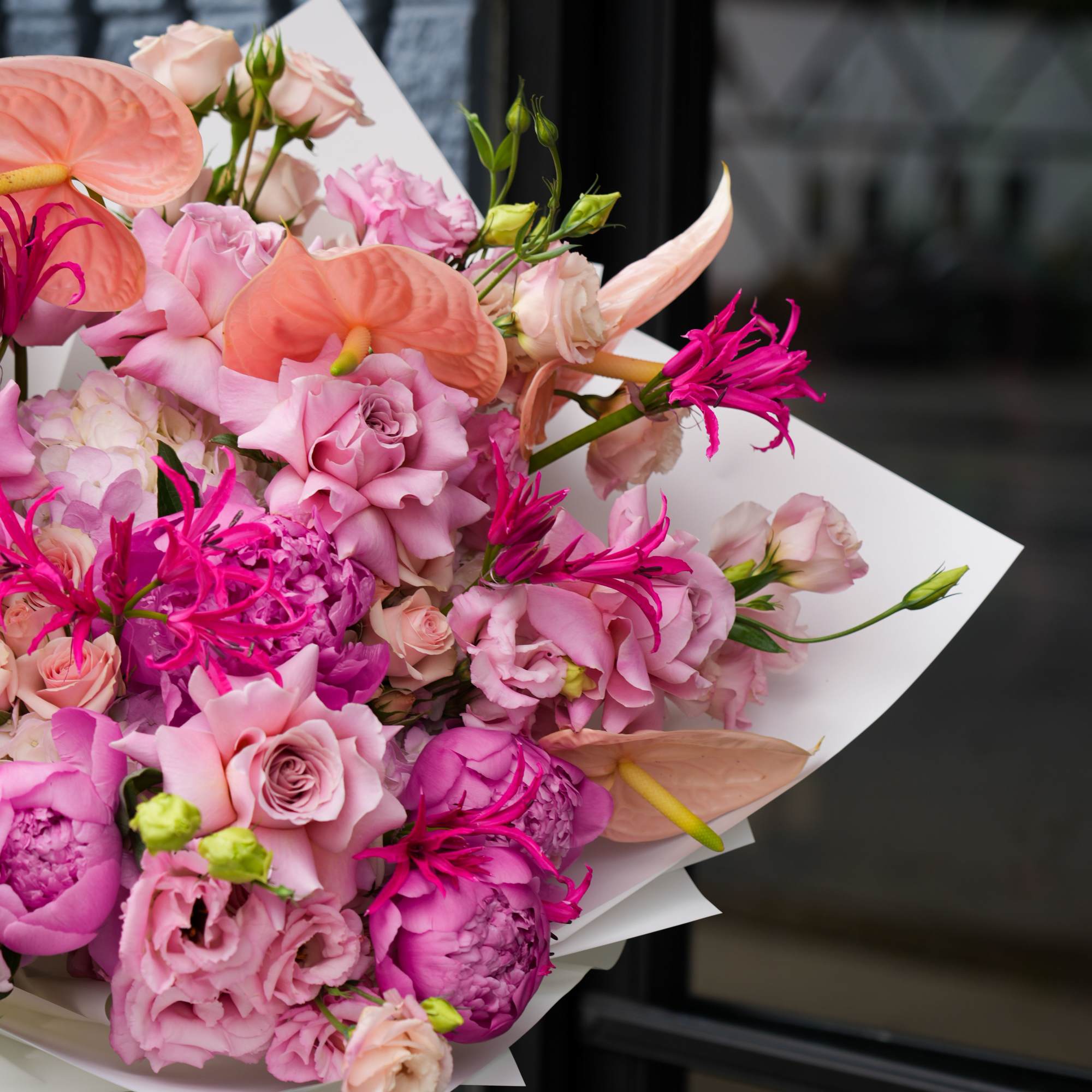 Pink and peach bouquet with roses, anthuriums, and lisianthus