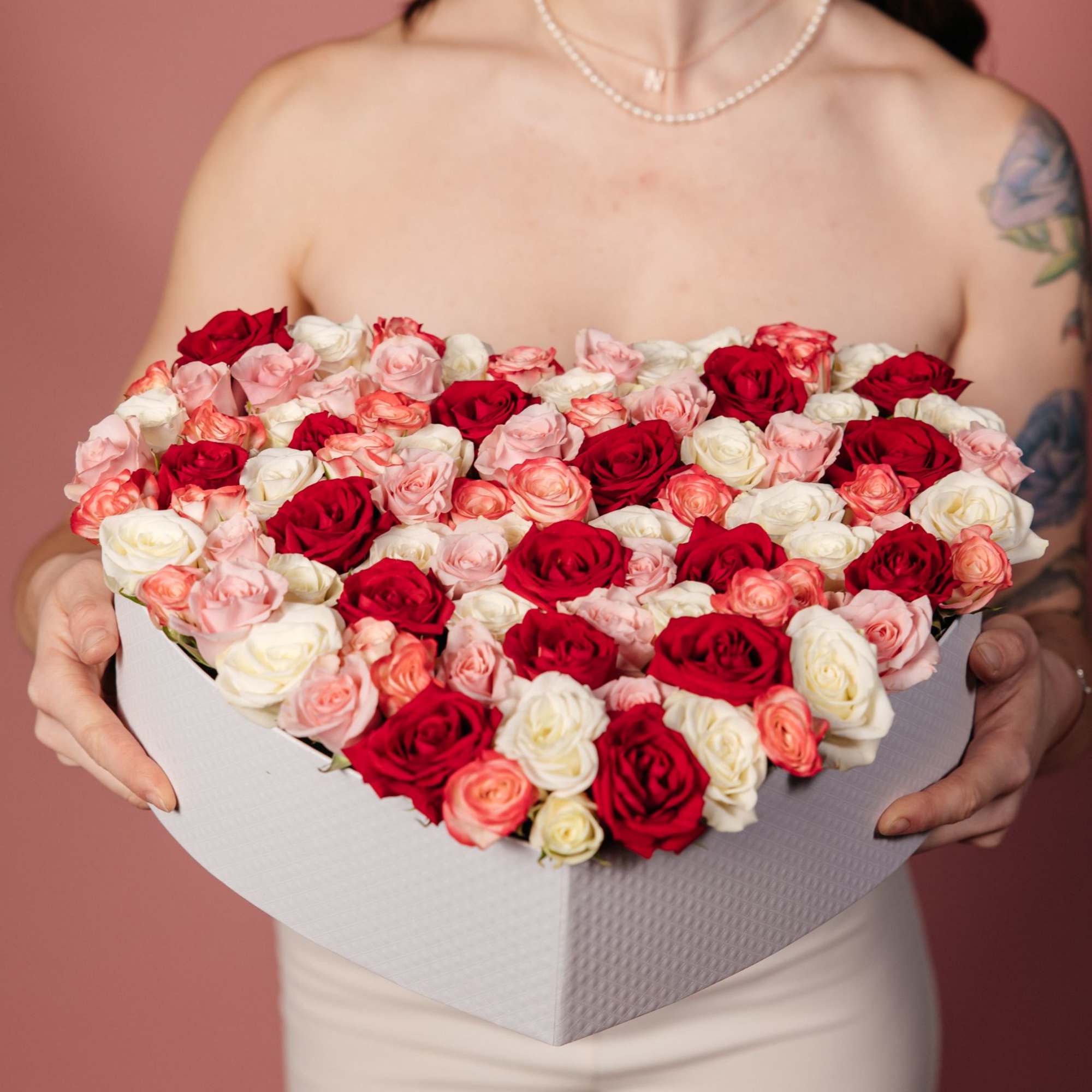 Heart-shaped box of red, pink, and white roses