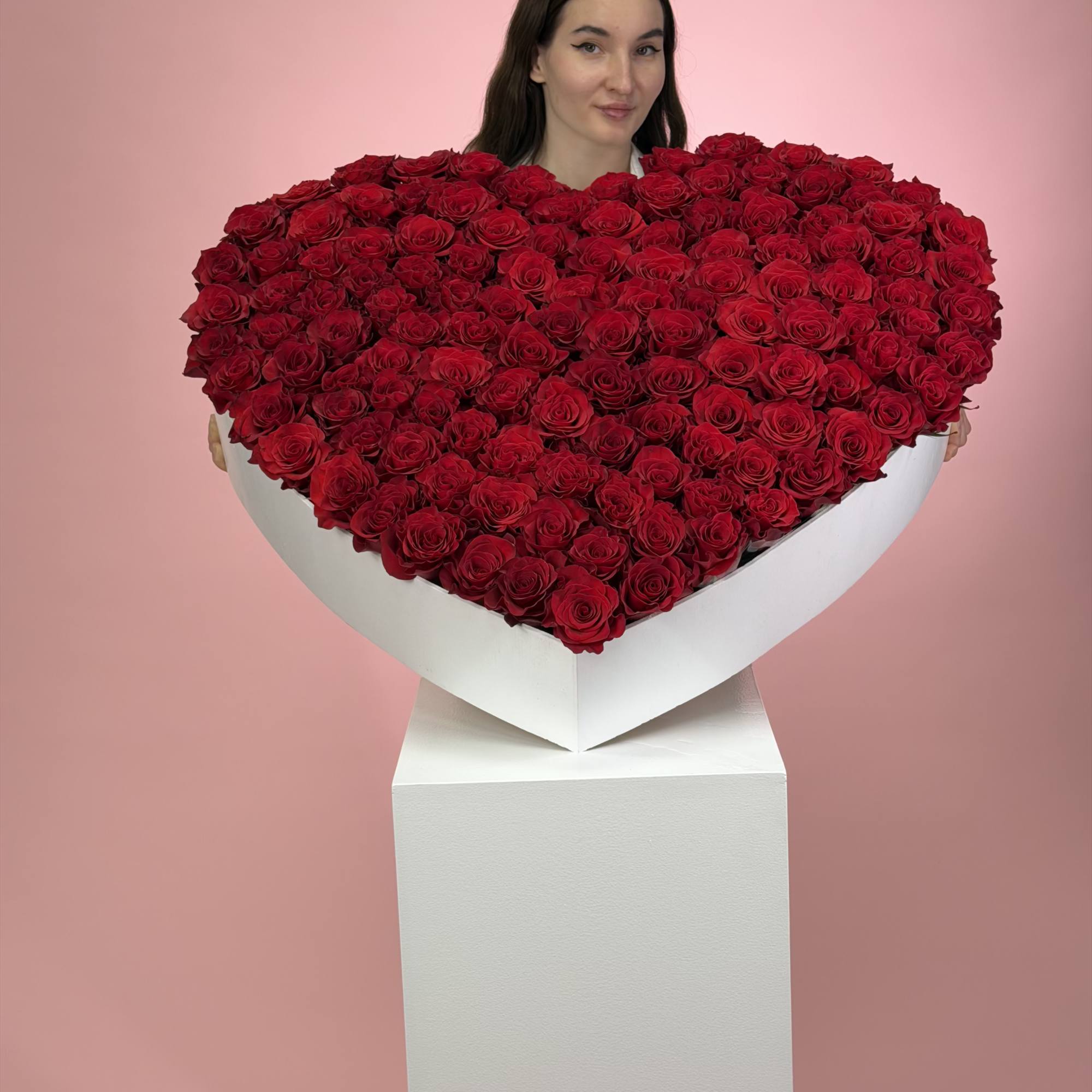 Heart-shaped arrangement of red roses in a white box