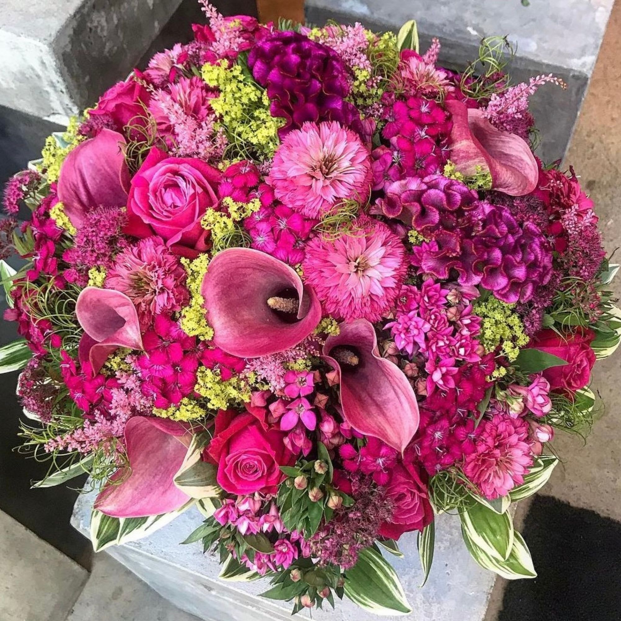 Large bouquet of pink flowers with calla lilies and roses