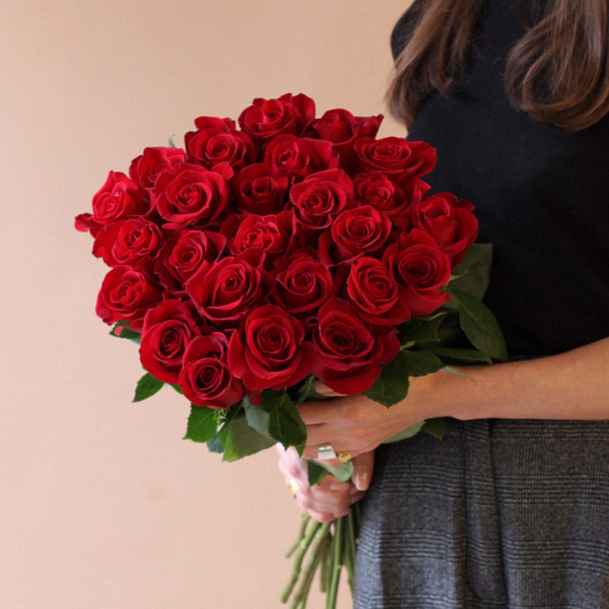 Bouquet of red roses held by a person