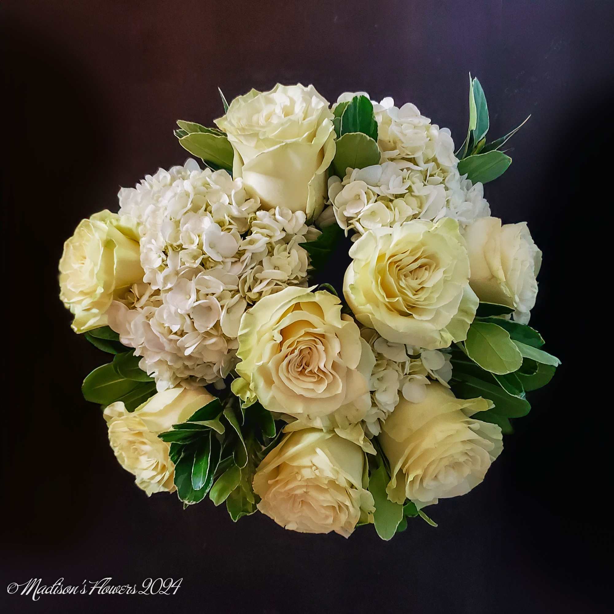 Classic round table-top arrangement featuring cream colored roses, accent flowers in soft, photo 2 of 4