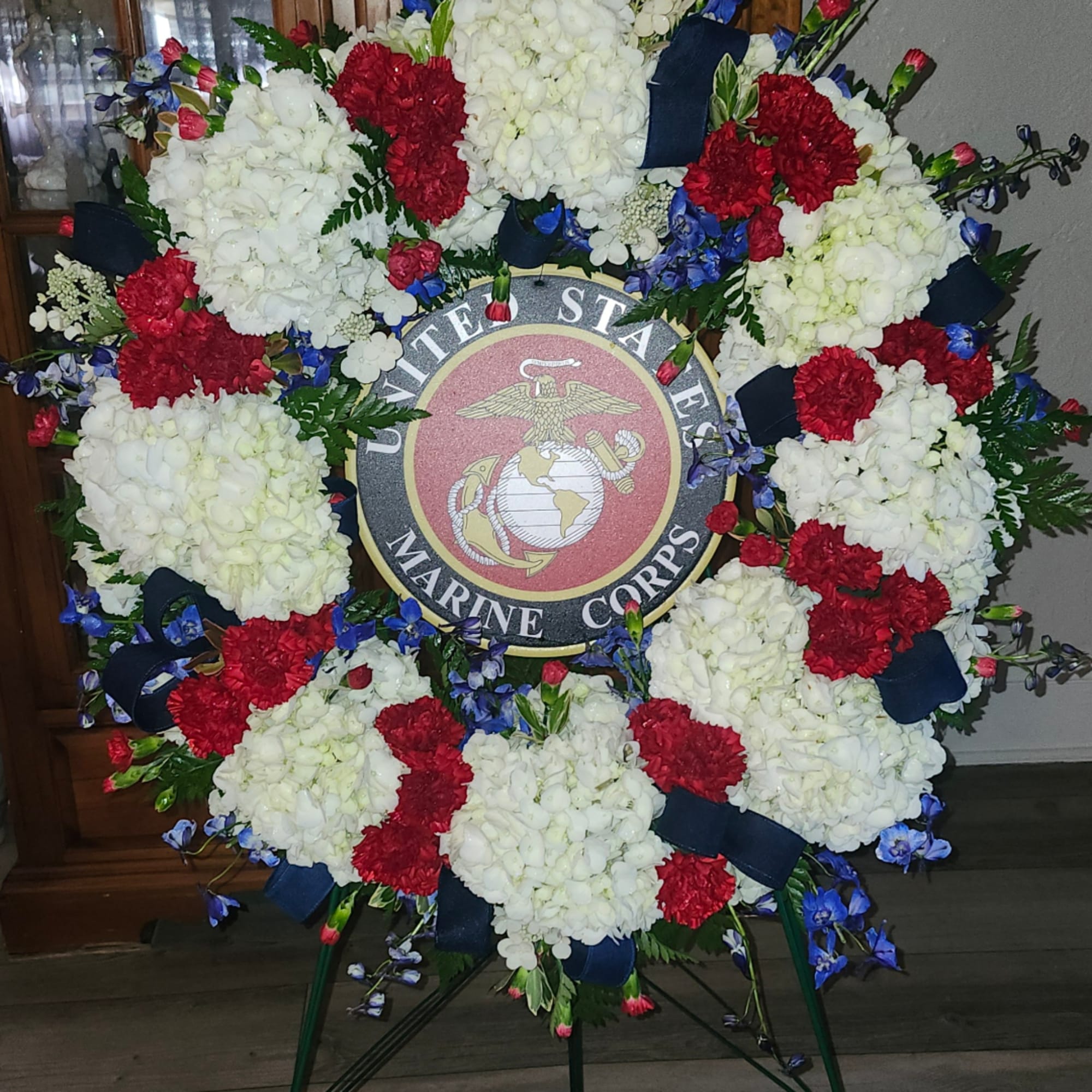 Large floral wreath around a United States Marine Corps emblem