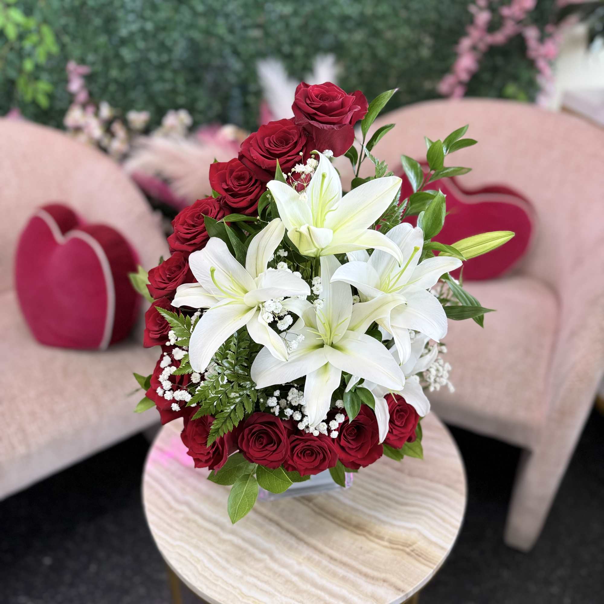 Red roses and white lilies arranged in a compact bouquet