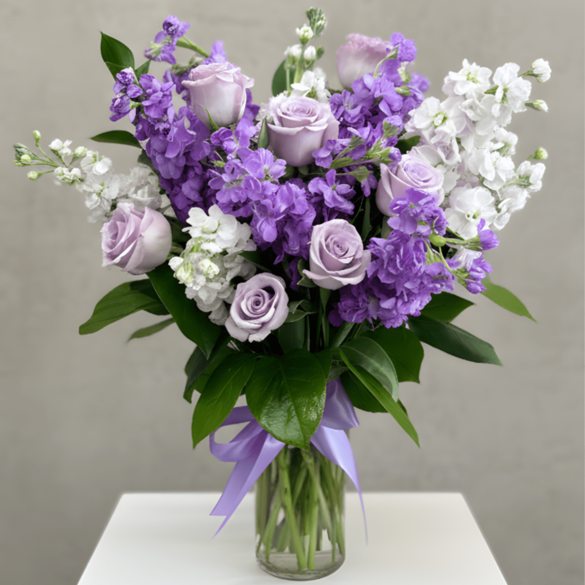 A soft and elegant arrangement featuring delicate lavender looms. Designed in a