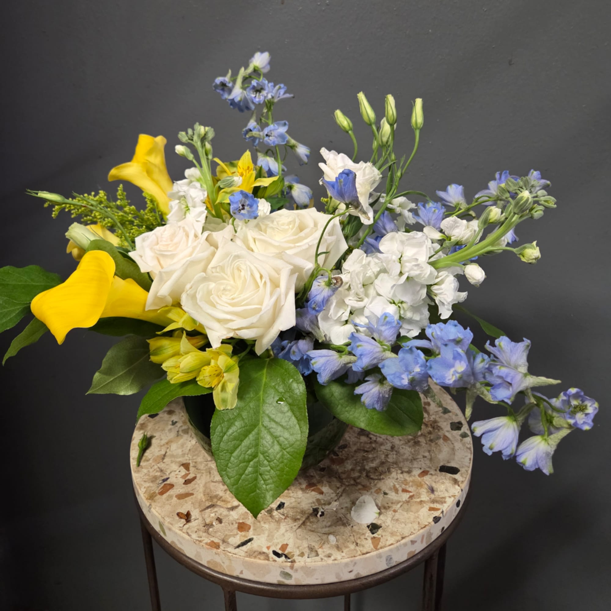 Bouquet of white roses, yellow calla lilies, and blue flowers in a vase, photo 4 of 4