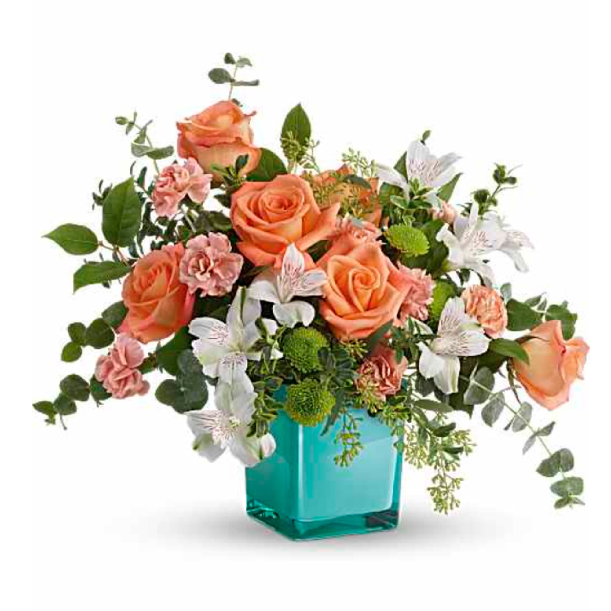 Peach roses and white flowers in a turquoise glass vase