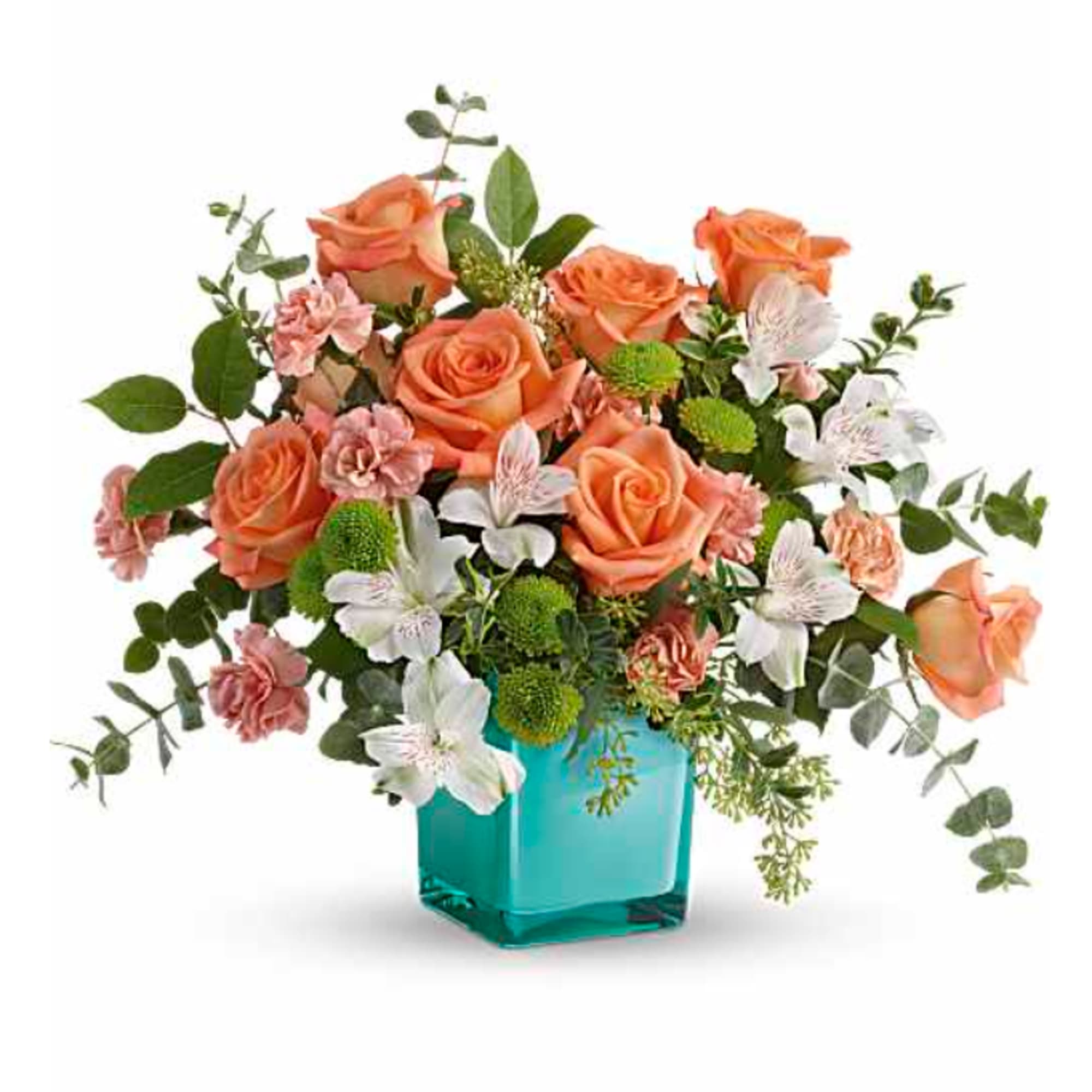 Peach roses and white flowers in a turquoise glass vase