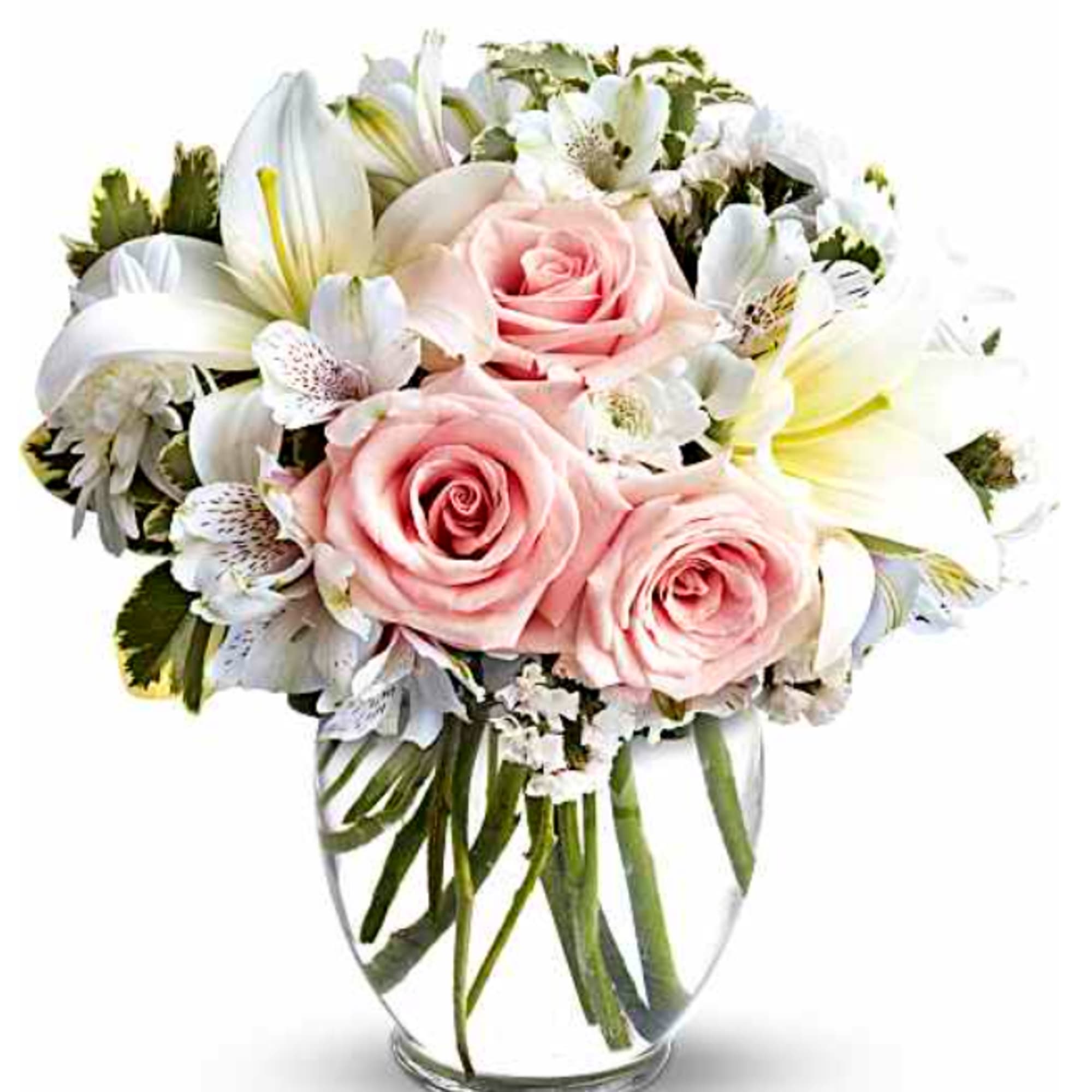Pink roses and white lilies arranged in a clear glass vase