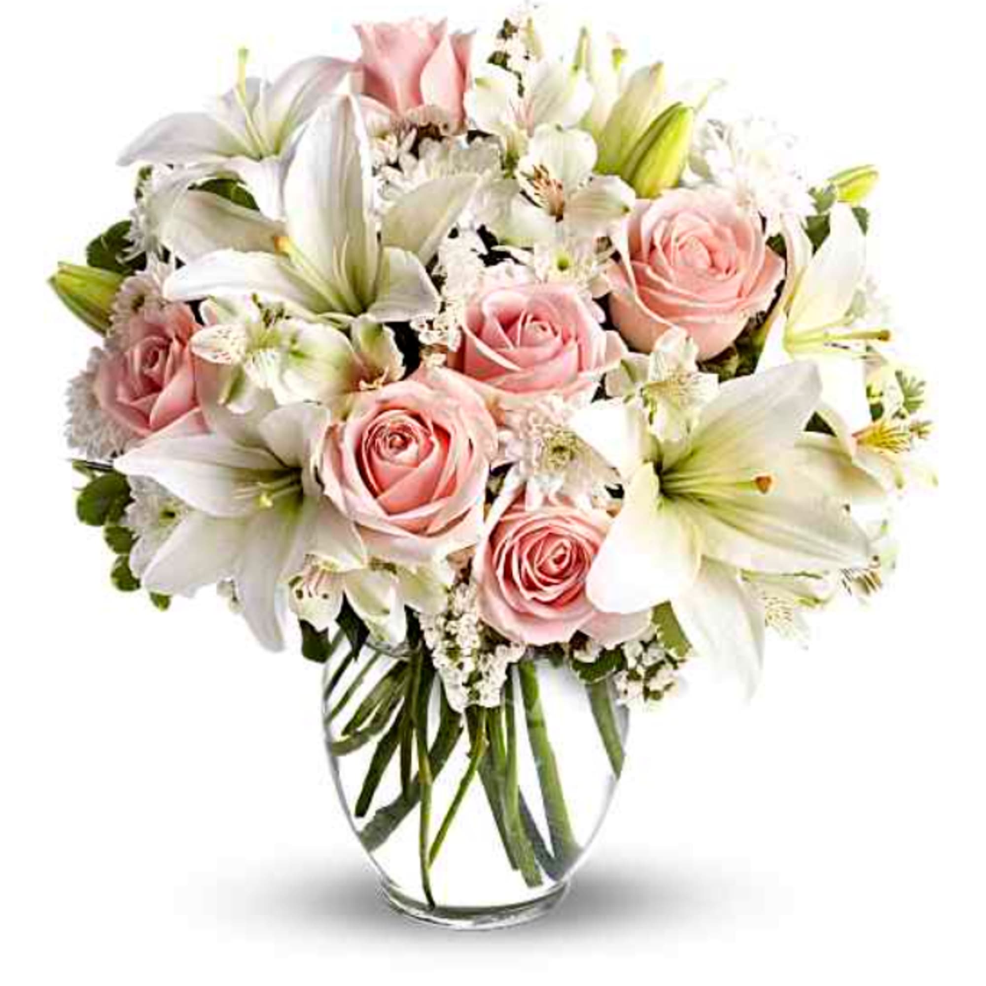 Pink roses and white lilies arranged in a clear glass vase