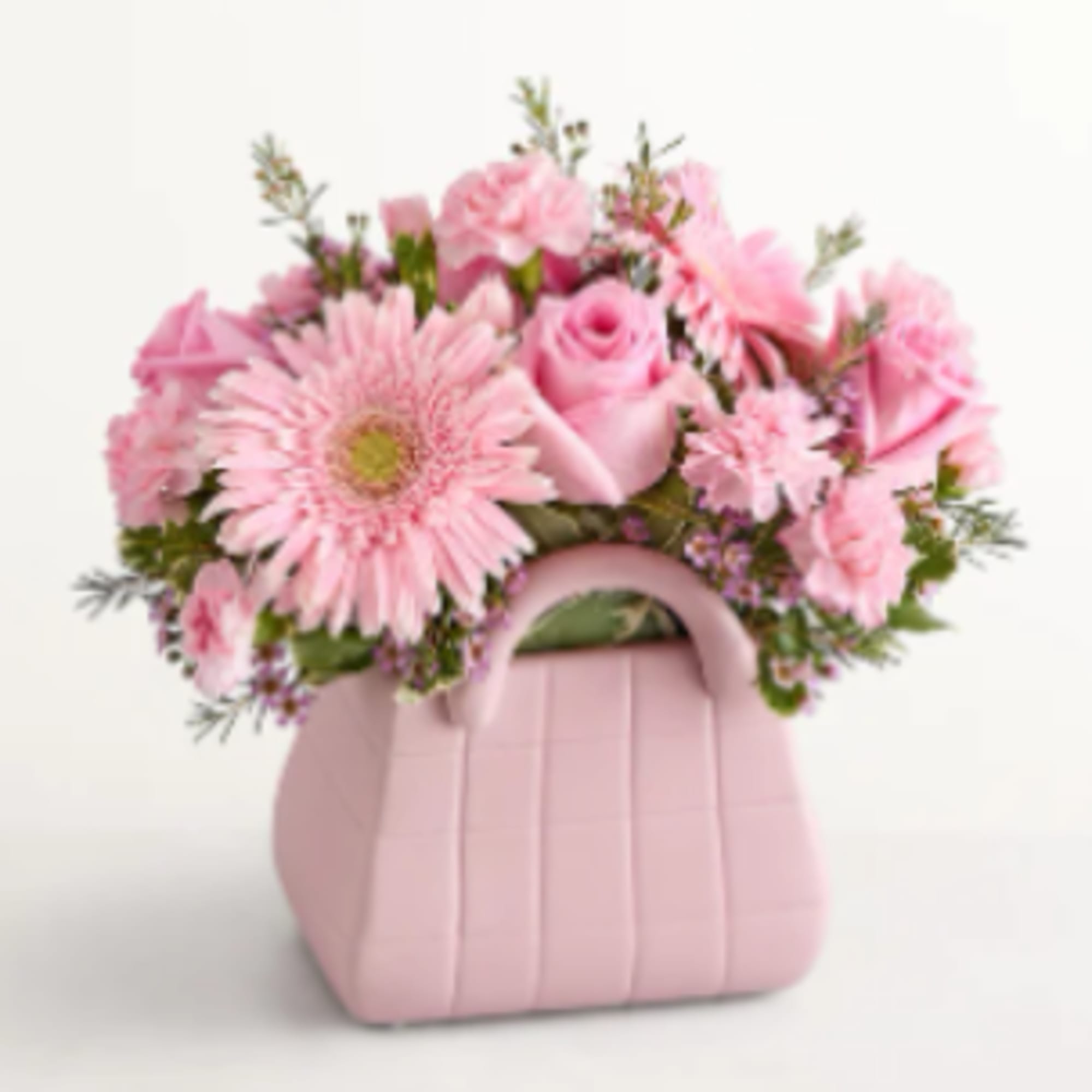 A cheerful cluster of soft pink gerbera daisies, roses, and carnations arranged