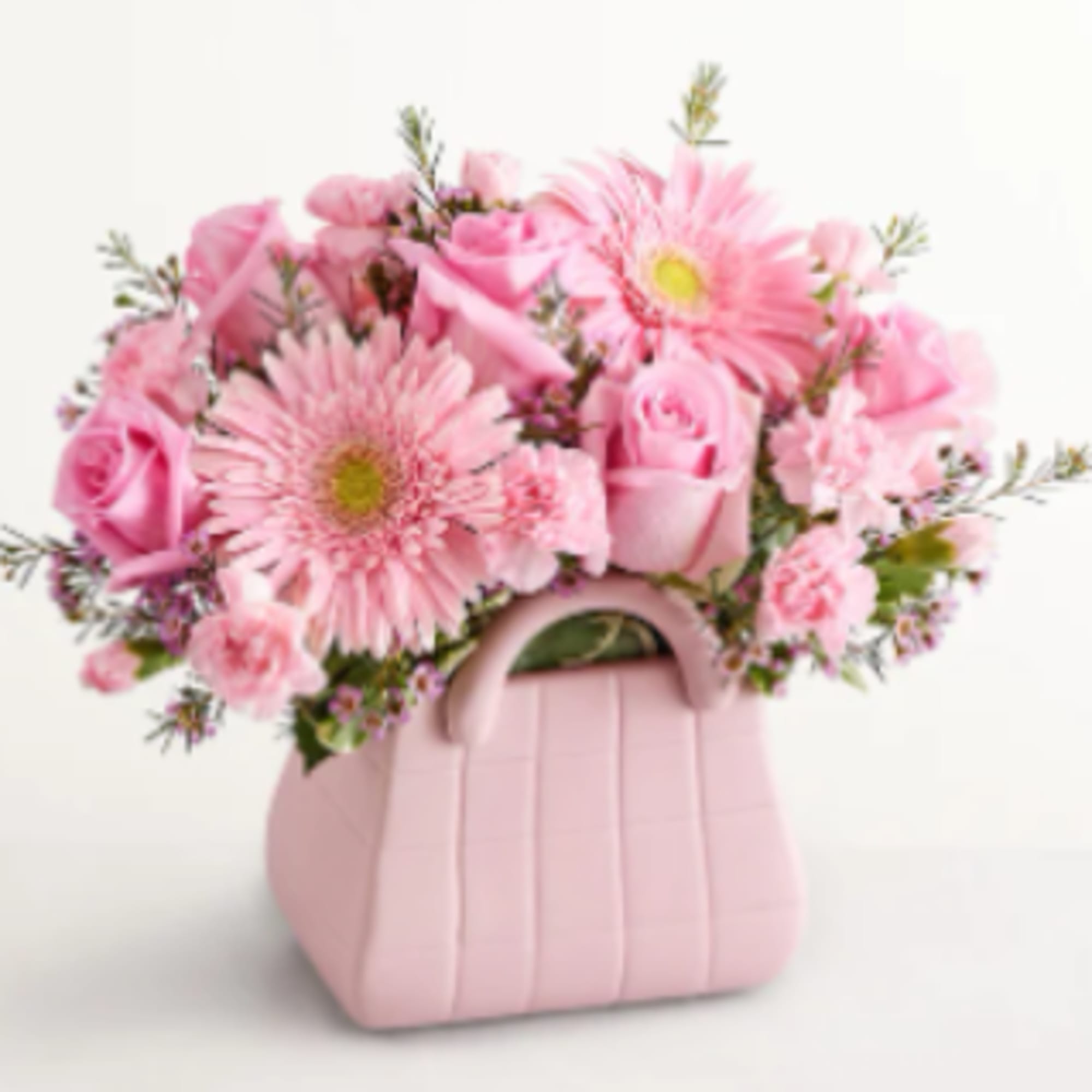 A cheerful cluster of soft pink gerbera daisies, roses, and carnations arranged