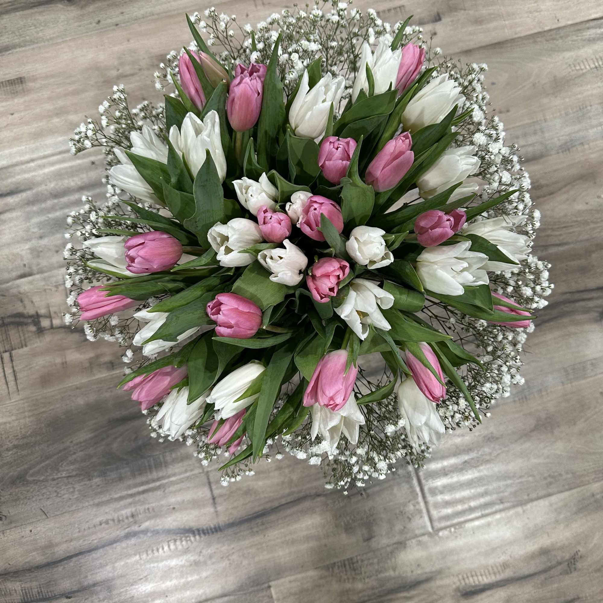 Round bouquet of pink and white tulips with baby's breath