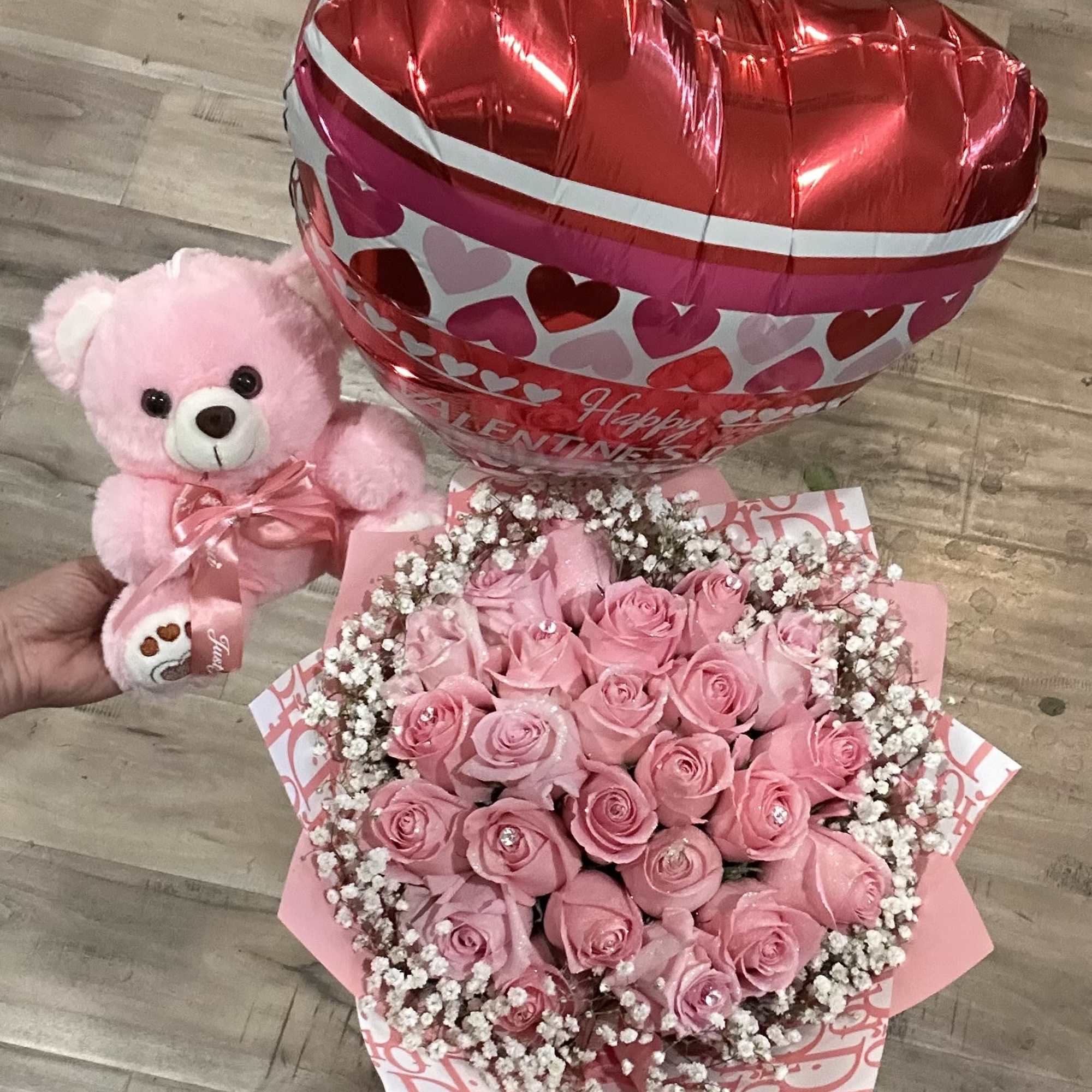 Pink rose bouquet with a teddy bear and heart-shaped balloon