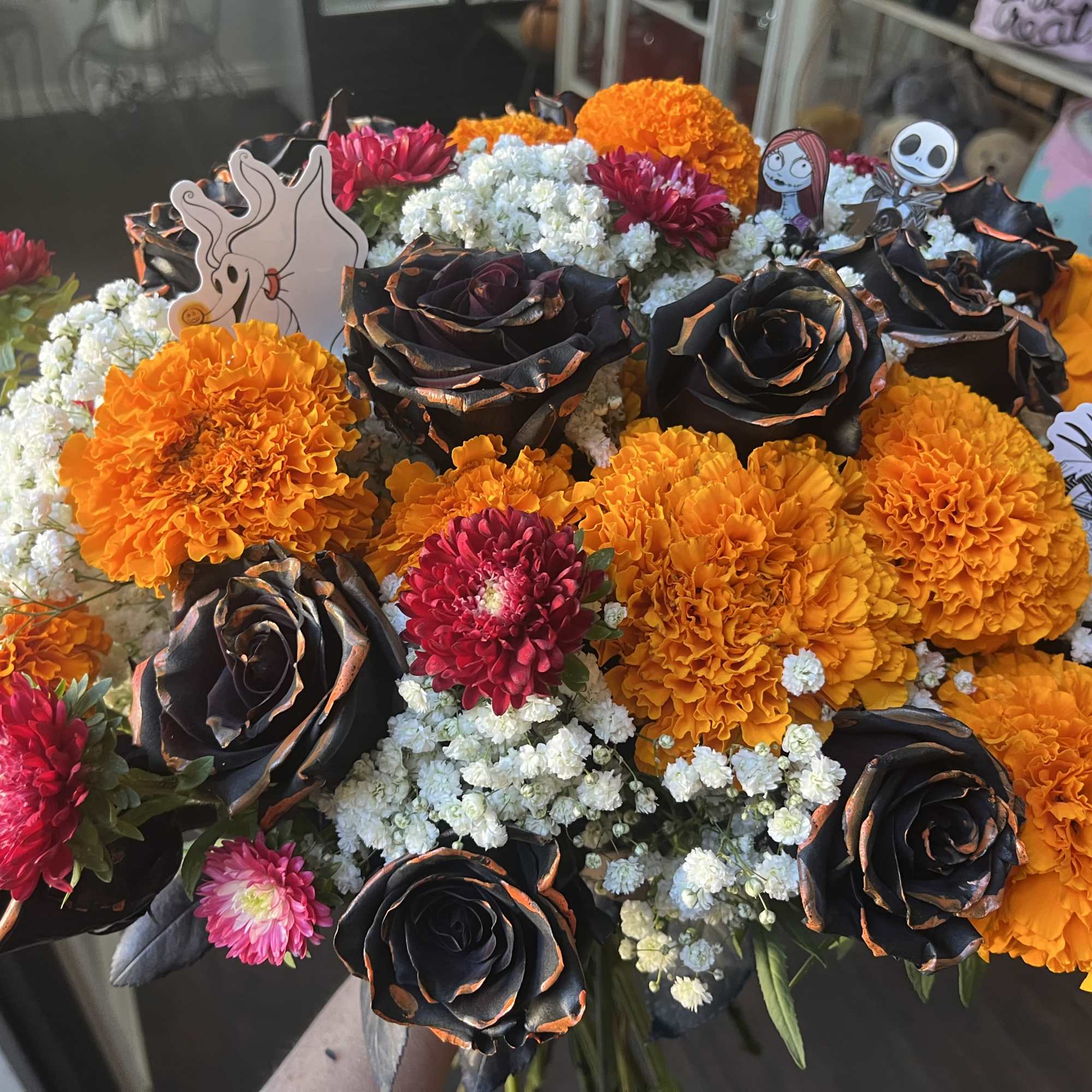 A dozen roses, marigolds, baby&rsquo;s breath, and asters With nightmare before Christmas, photo 2 of 2