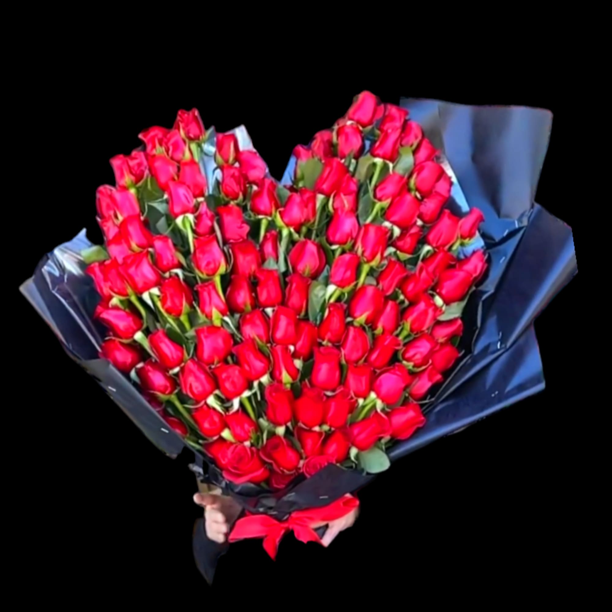 Large bouquet of red roses wrapped in dark paper with a red ribbon