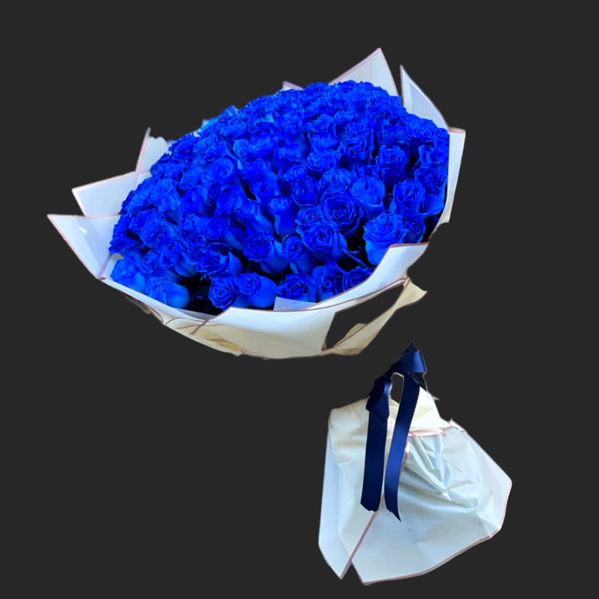 Large bouquet of vivid blue roses wrapped in white paper with a navy ribbon