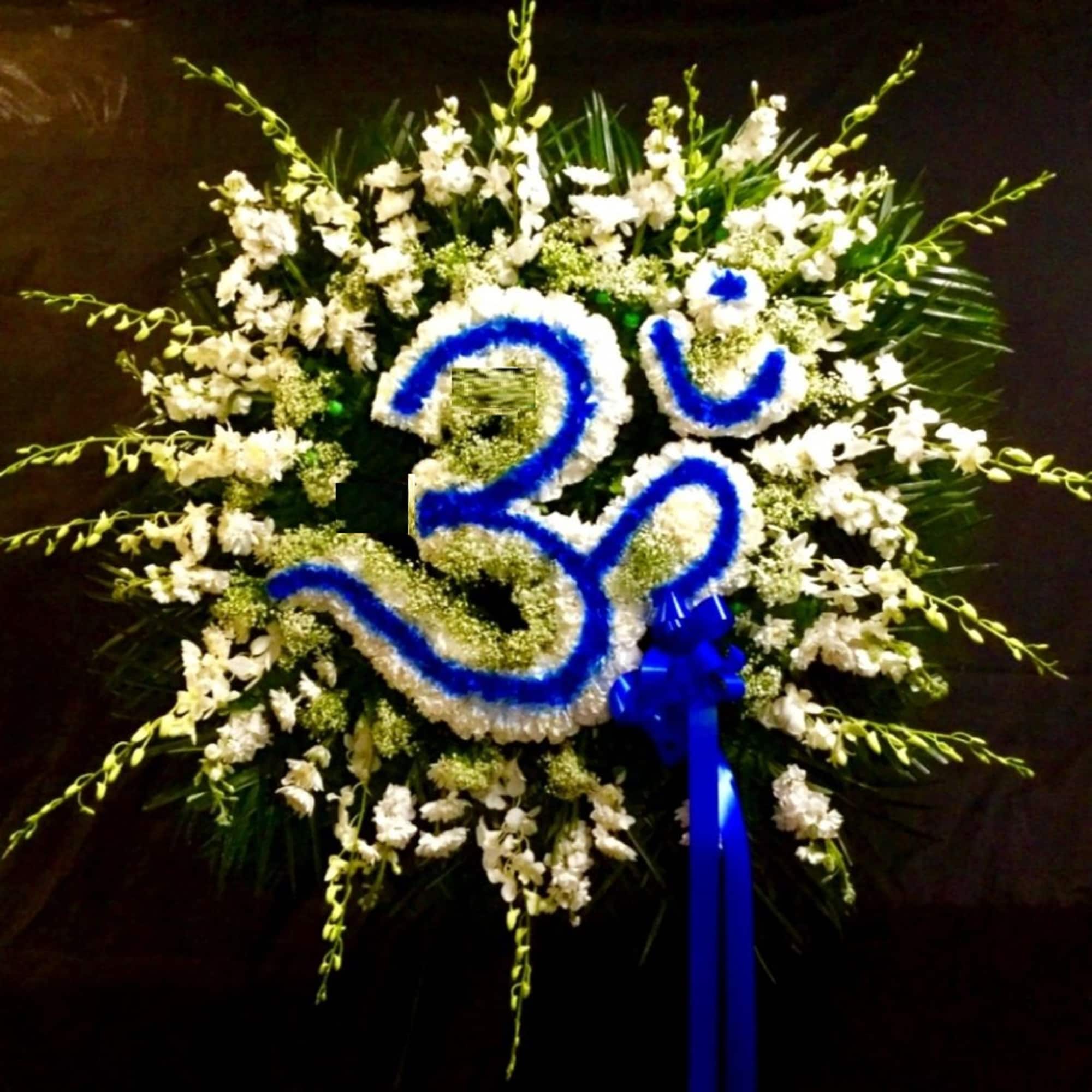 White floral wreath with a blue number 30 and ribbon