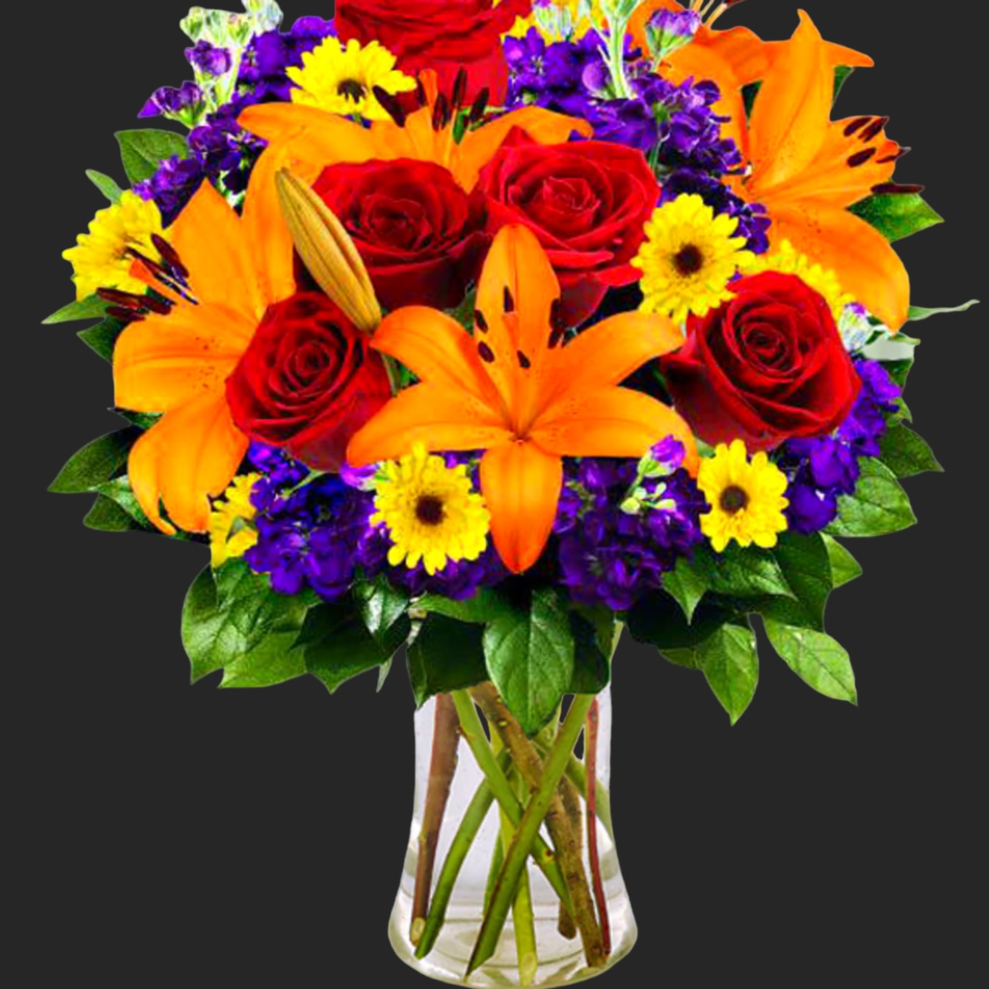 Bouquet of red roses, orange lilies, and yellow daisies in a clear vase