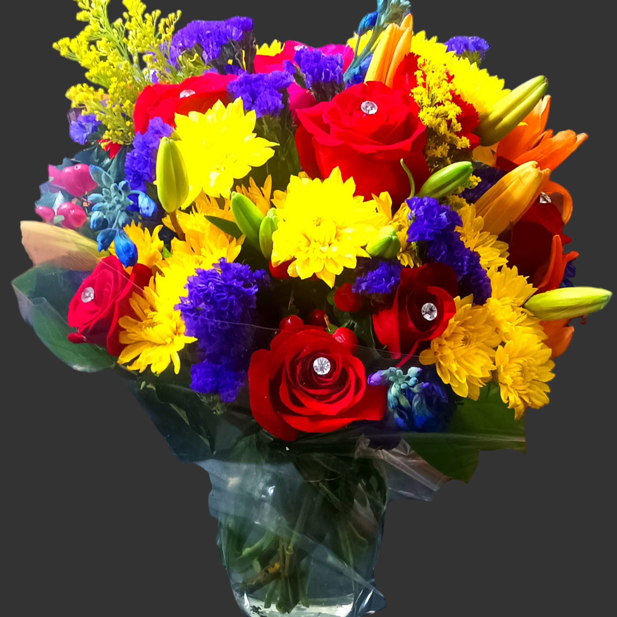 Colorful bouquet of roses, lilies, and daisies in clear wrap