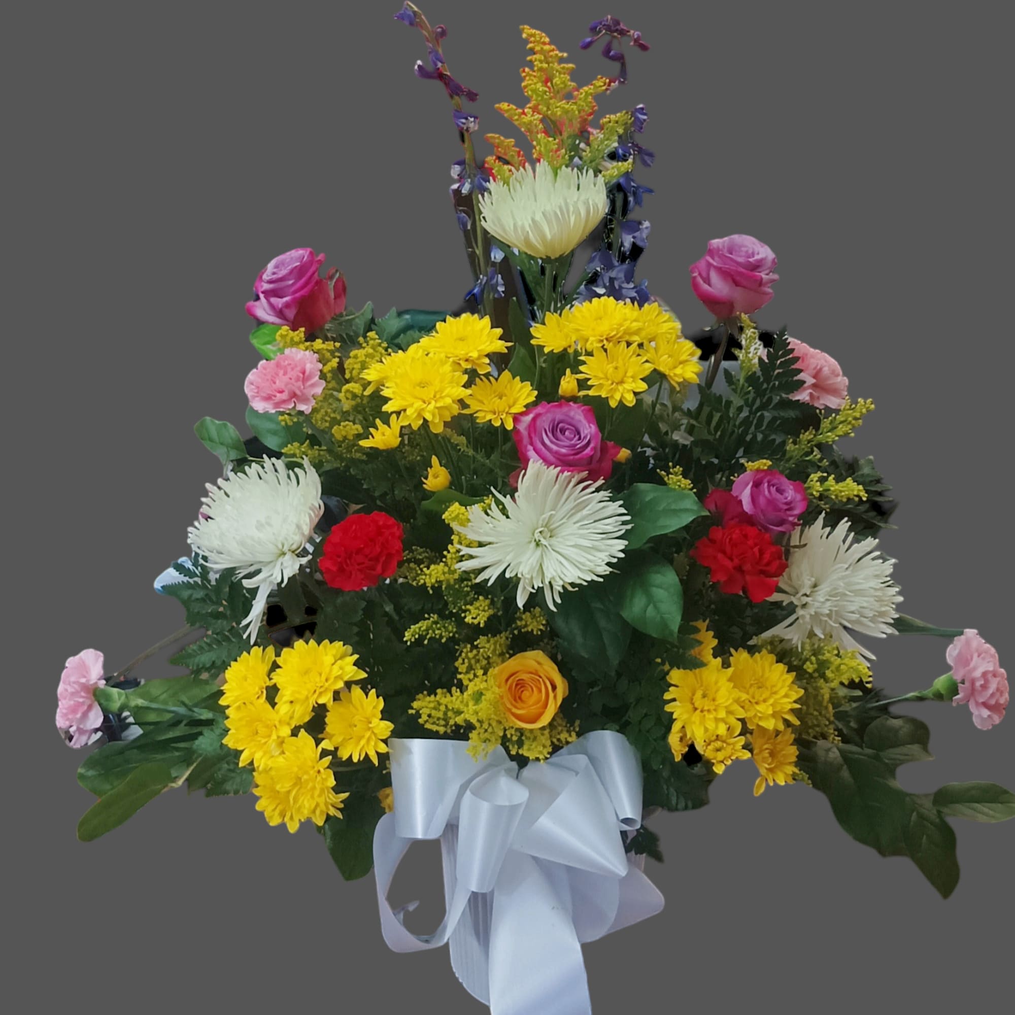 Colorful mixed flower arrangement with a white ribbon bow