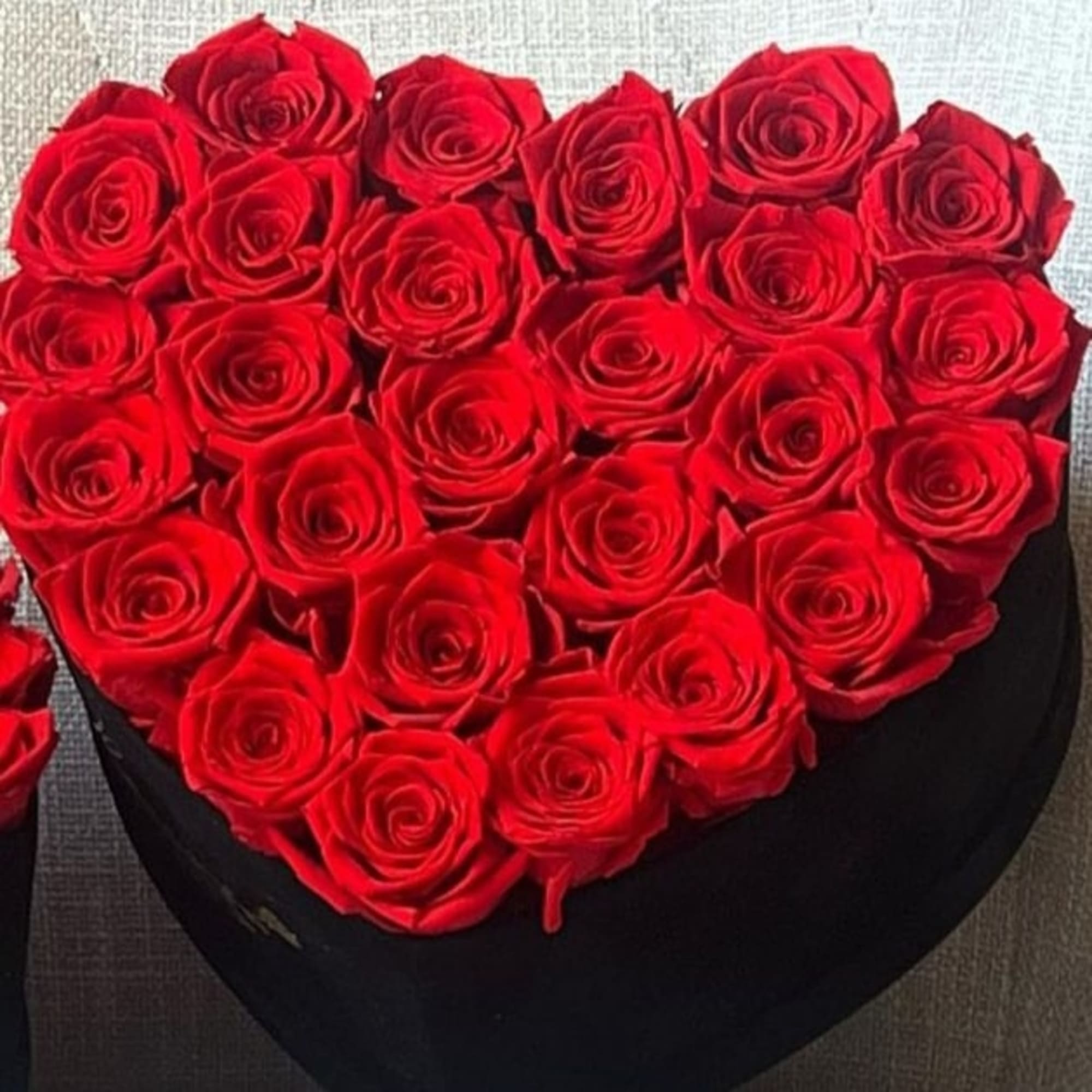 Heart-shaped box filled with red roses