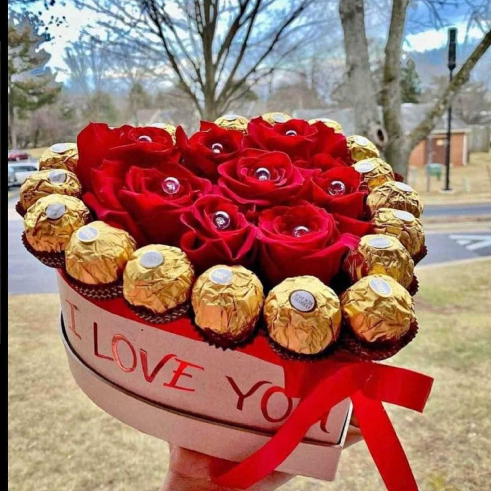 Heart-shaped box of red roses and gold-wrapped chocolates with a red ribbon, photo 14 of 18