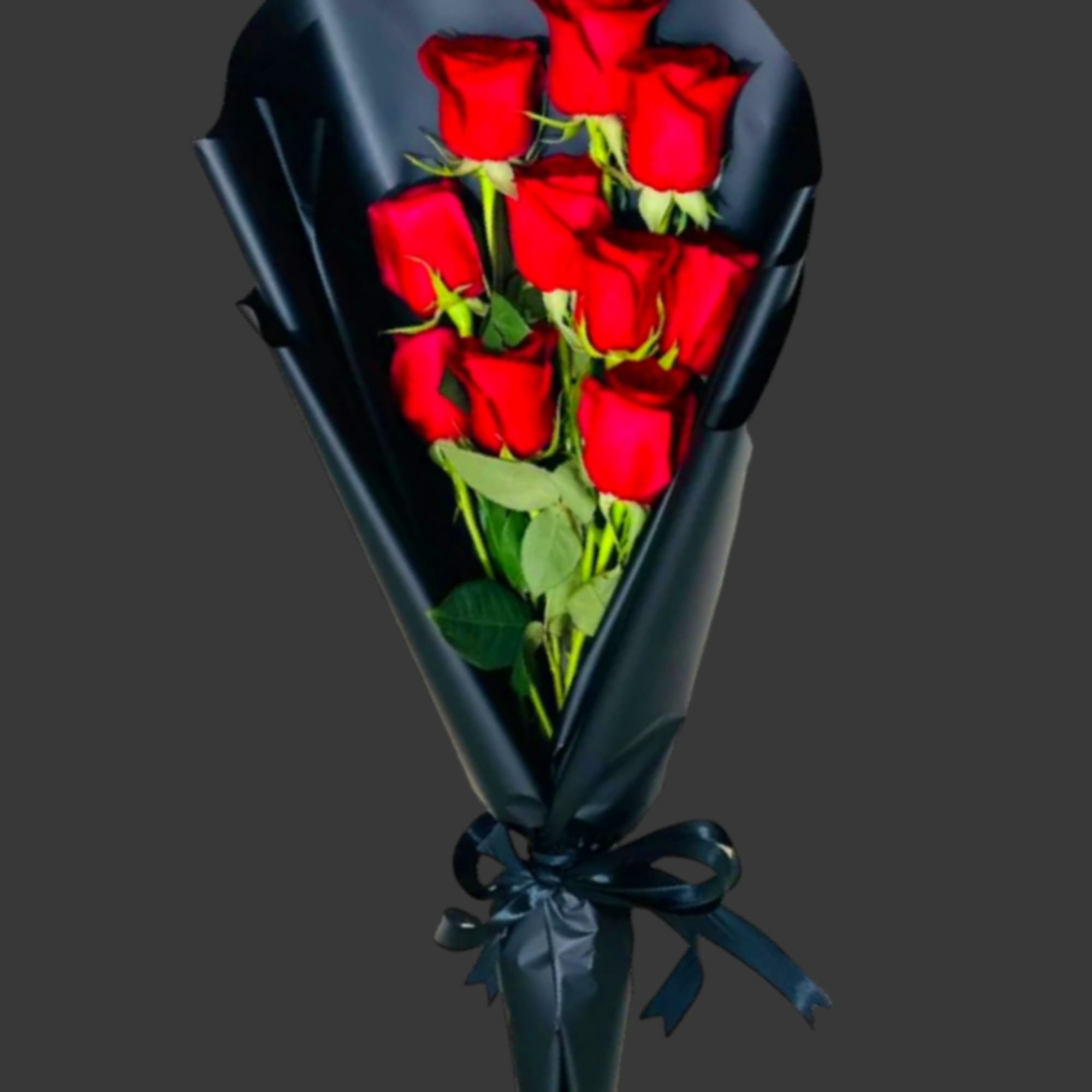Bouquet of red roses wrapped in dark paper with a ribbon