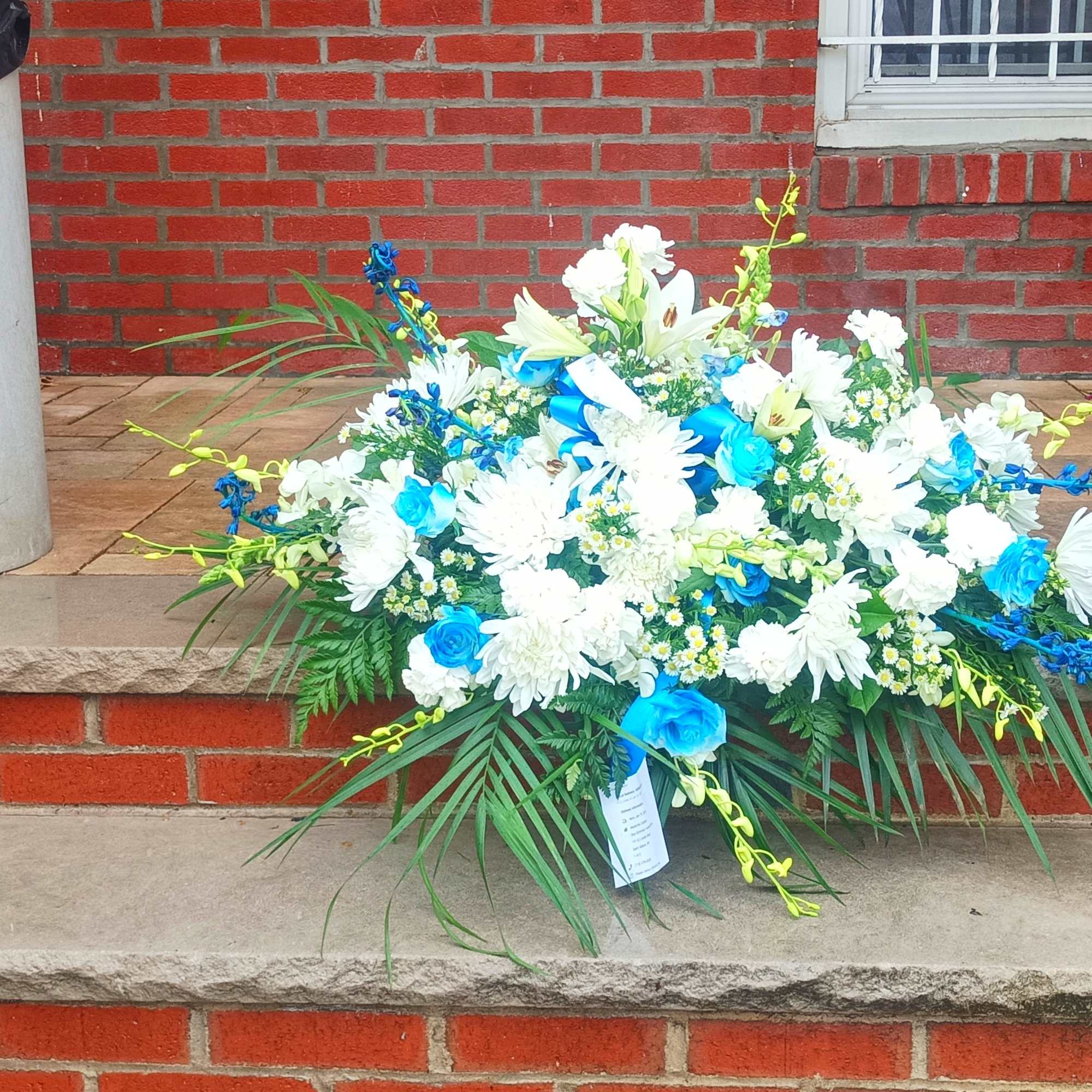 Blue and white floral arrangement on a front step