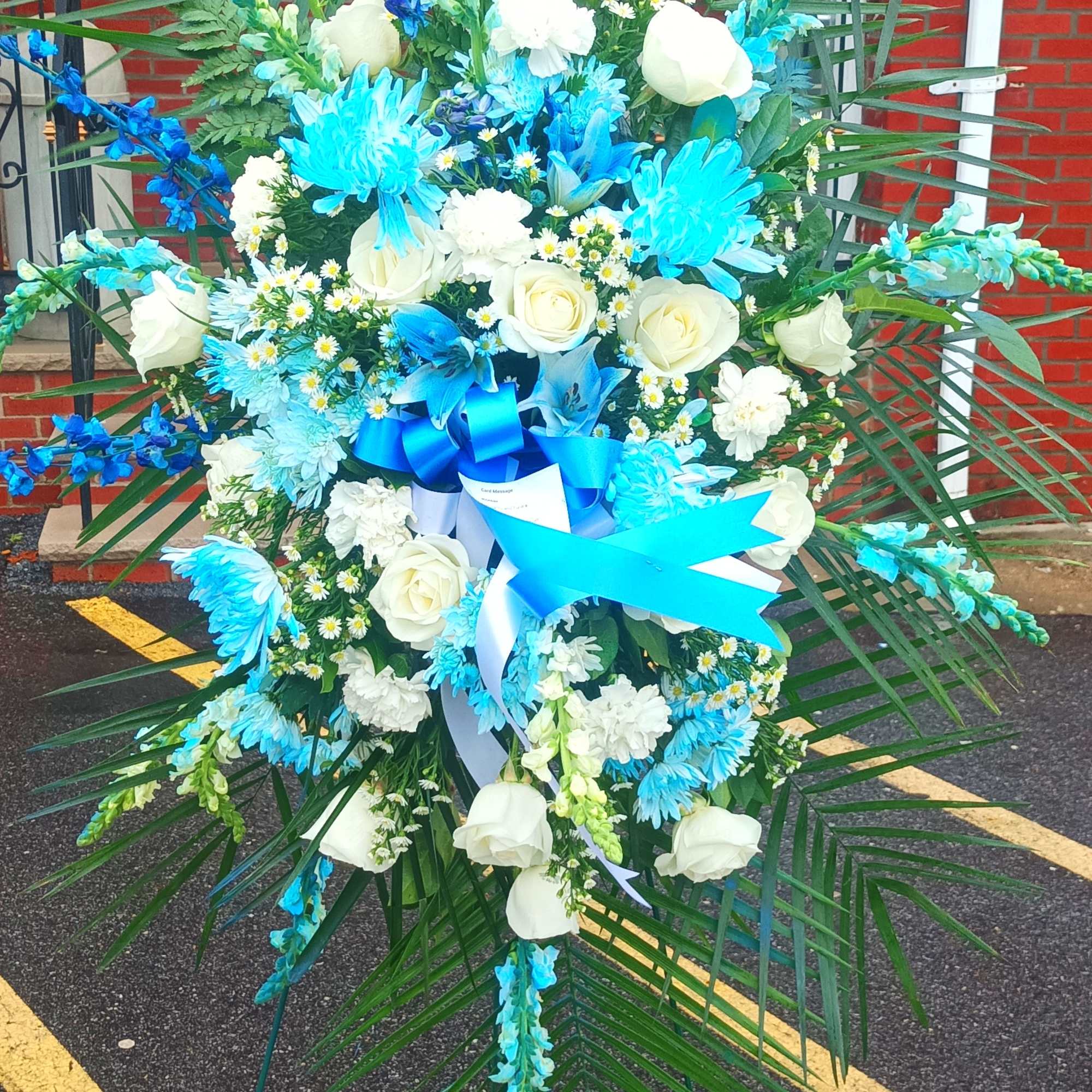 Large standing floral spray with white roses and bright blue flowers, photo 4 of 10