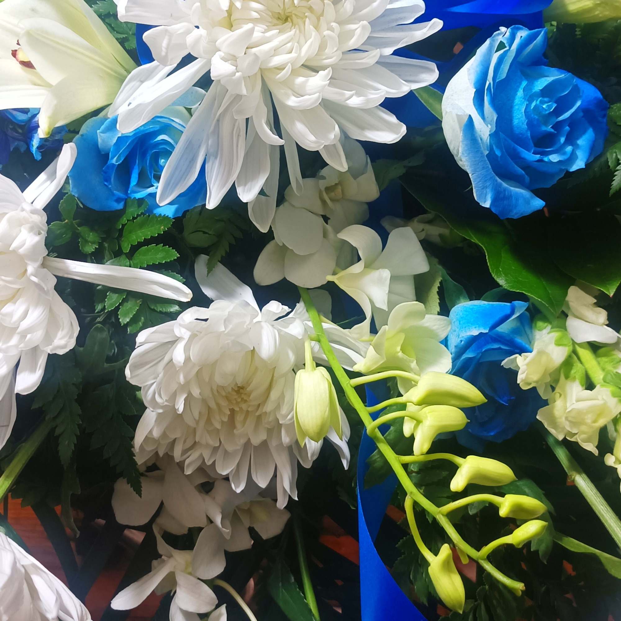 Blue and white floral arrangement with ribbon accents