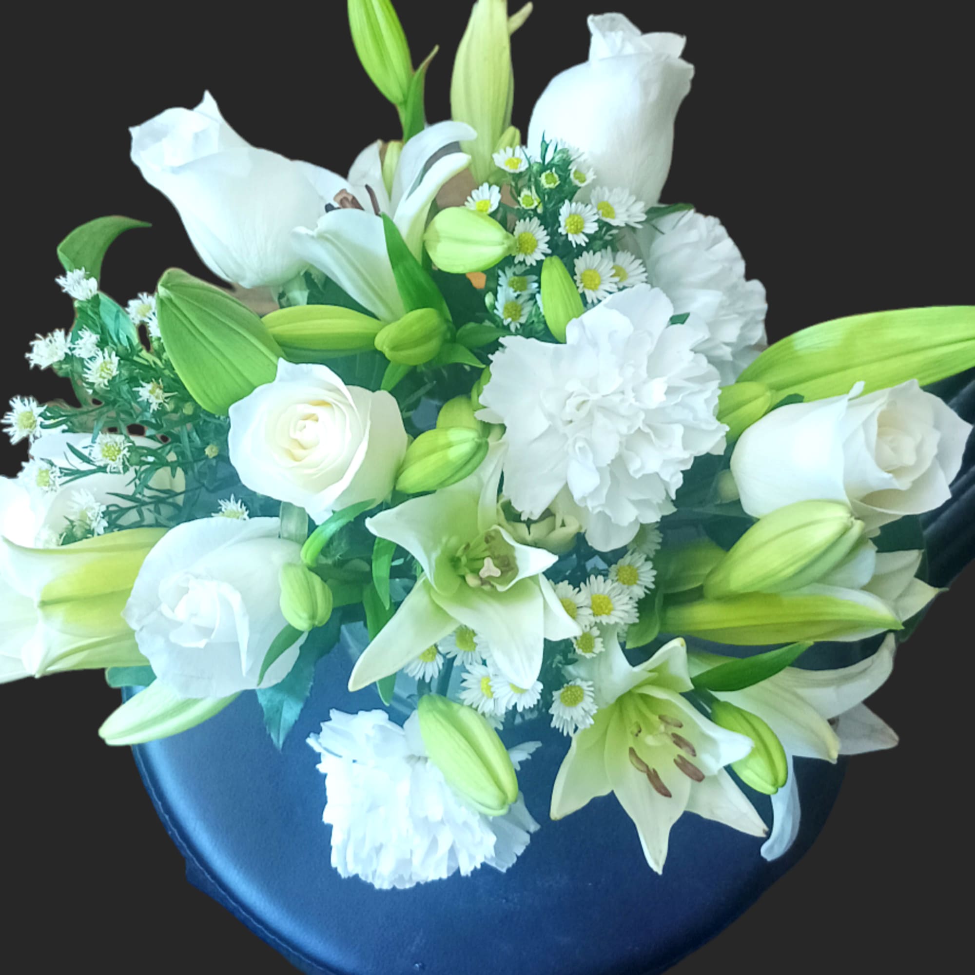 This arrangement includes white roses, white asiatic lilies, white and white carnations., photo 2 of 3